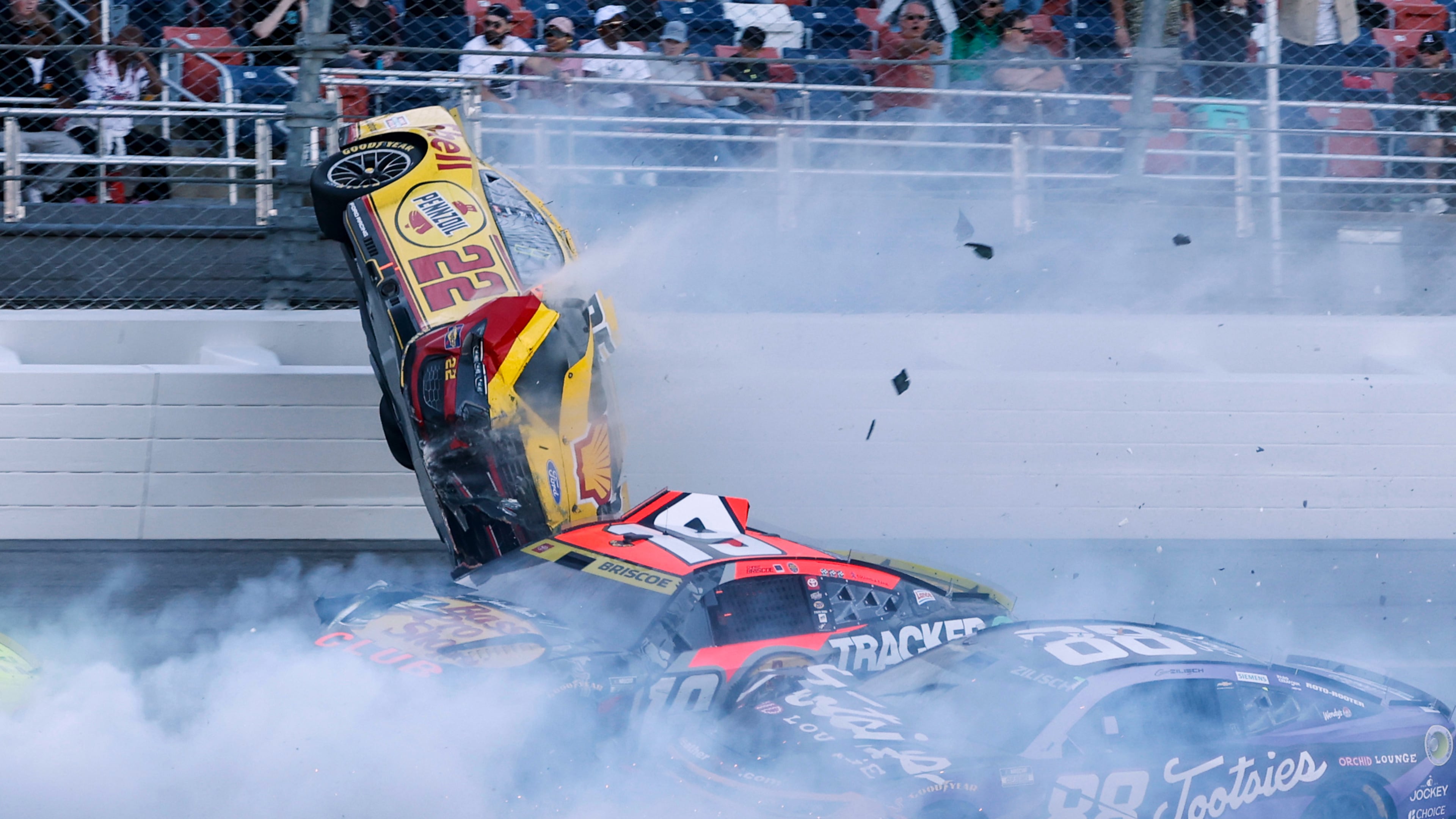 Joey Logano (22) flips after wrecking with Chase Briscoe (19) and involving multiple drivers in the tri-oval during a NASCAR Cup Series auto race Sunday, Oct. 25, 2026, in Talladega, Ala. (AP Photo/Butch Dill)