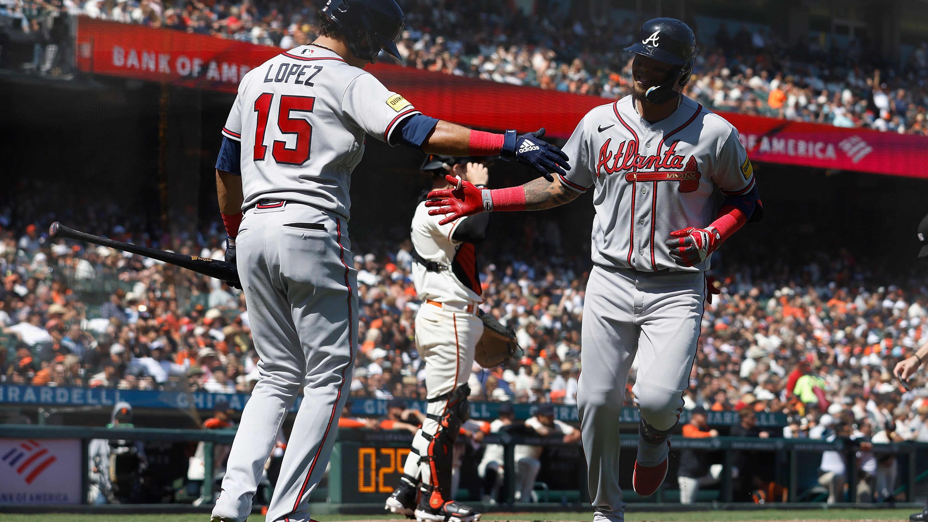 Orlando Arcia (11) of the Braves celebrates with Nicky Lopez (15) after hitting a solo home run in the top of the sixth inning against the San Francisco Giants at Oracle Park on Aug. 26, 2023, in San Francisco. (Lachlan Cunningham/Getty Images/TNS)