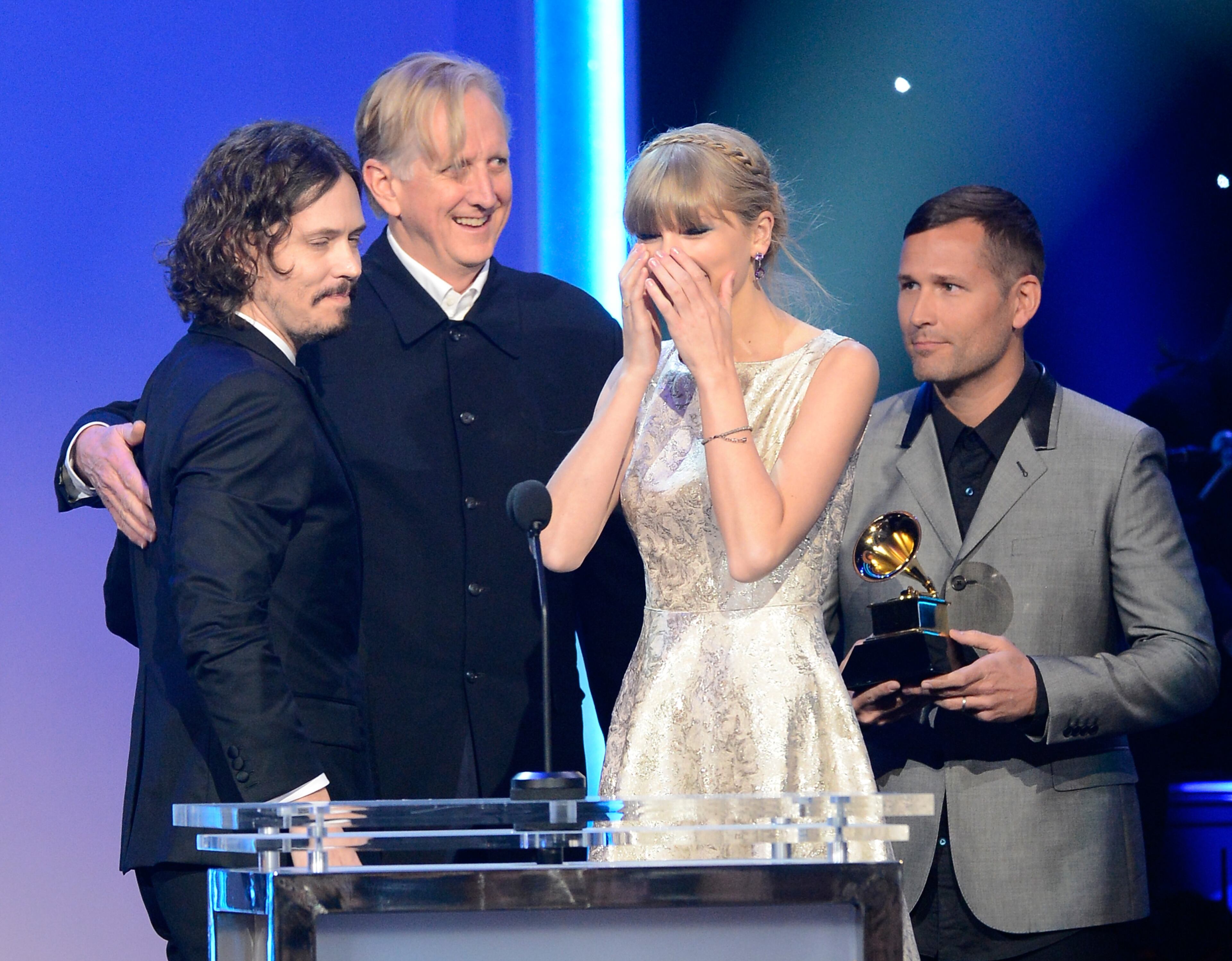 Kaskade (Far R) looks on as songerwriter John Paul White, musician T Bone Burnett and Taylor Swift accept the Best Song Written For Visual Media Award for "Safe & Sound (From The Hunger Games)" onstage at the The 55th Annual GRAMMY Awards at Nokia Theatre on February 10, 2013 in Los Angeles, California. (Photo by Kevork Djansezian/Getty Images)