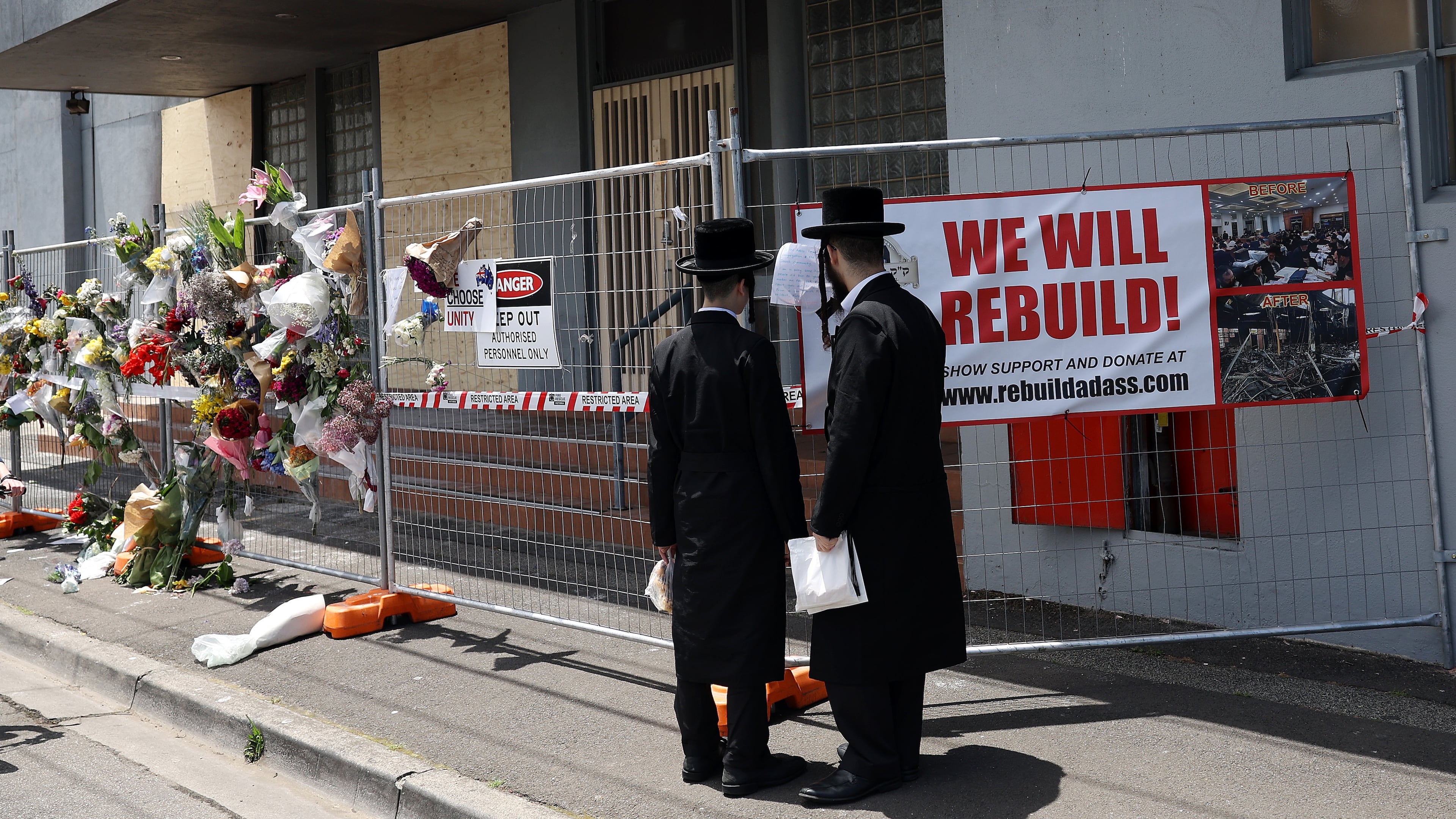 People gather outside the Adass Israel Synagogue, Dec. 9, 2024, after a firebombing in Melbourne, Australia. (Con Chronis/AAP Image via AP)