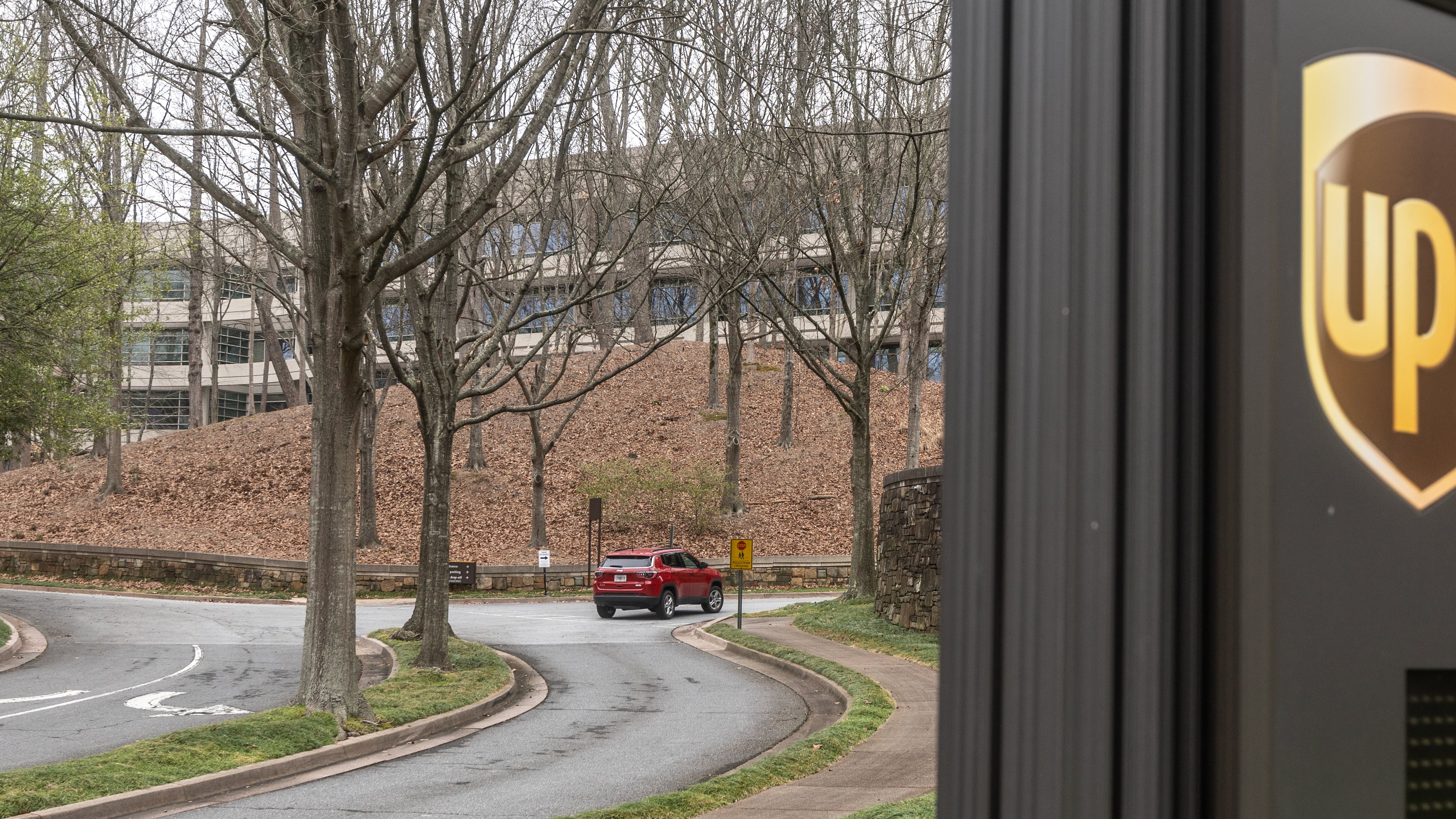 Cars arrive at 55 Glenlake Parkway NE, in Sandy Springs where office workers at UPS streamed back into work on Monday, March, 4, 2024 the first day a new policy requiring them to come into work in person five days a week took effect. The new policy, announced in January, (John Spink / John.Spink@ajc.com)