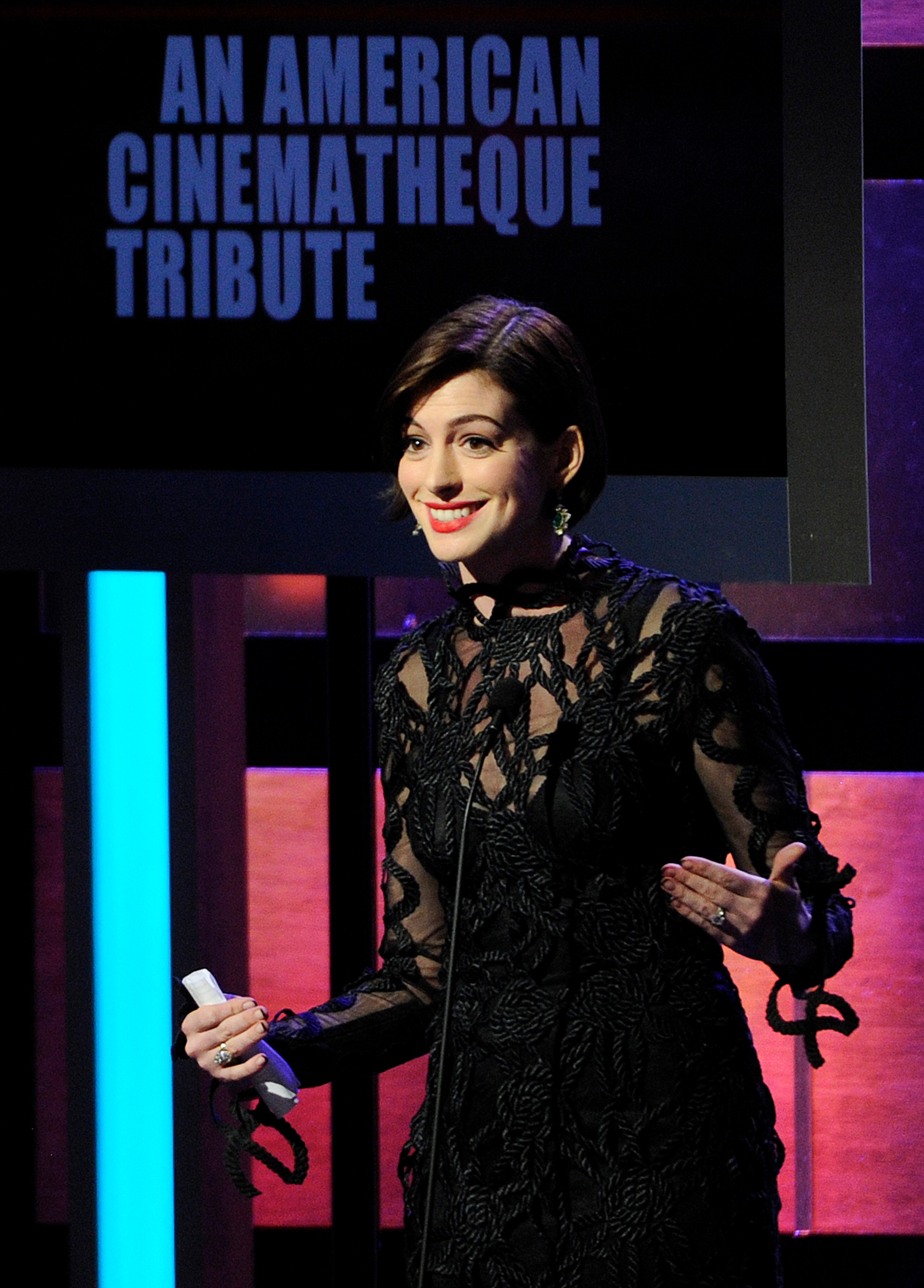 Actress Anne Hathaway addresses the audience during the American Cinematheque Award Presentation to Matthew McConaughey at the Beverly Hilton on Tuesday, Oct. 21, 2014, in Beverly Hills, Calif. (Photo by Chris Pizzello/Invision/AP)