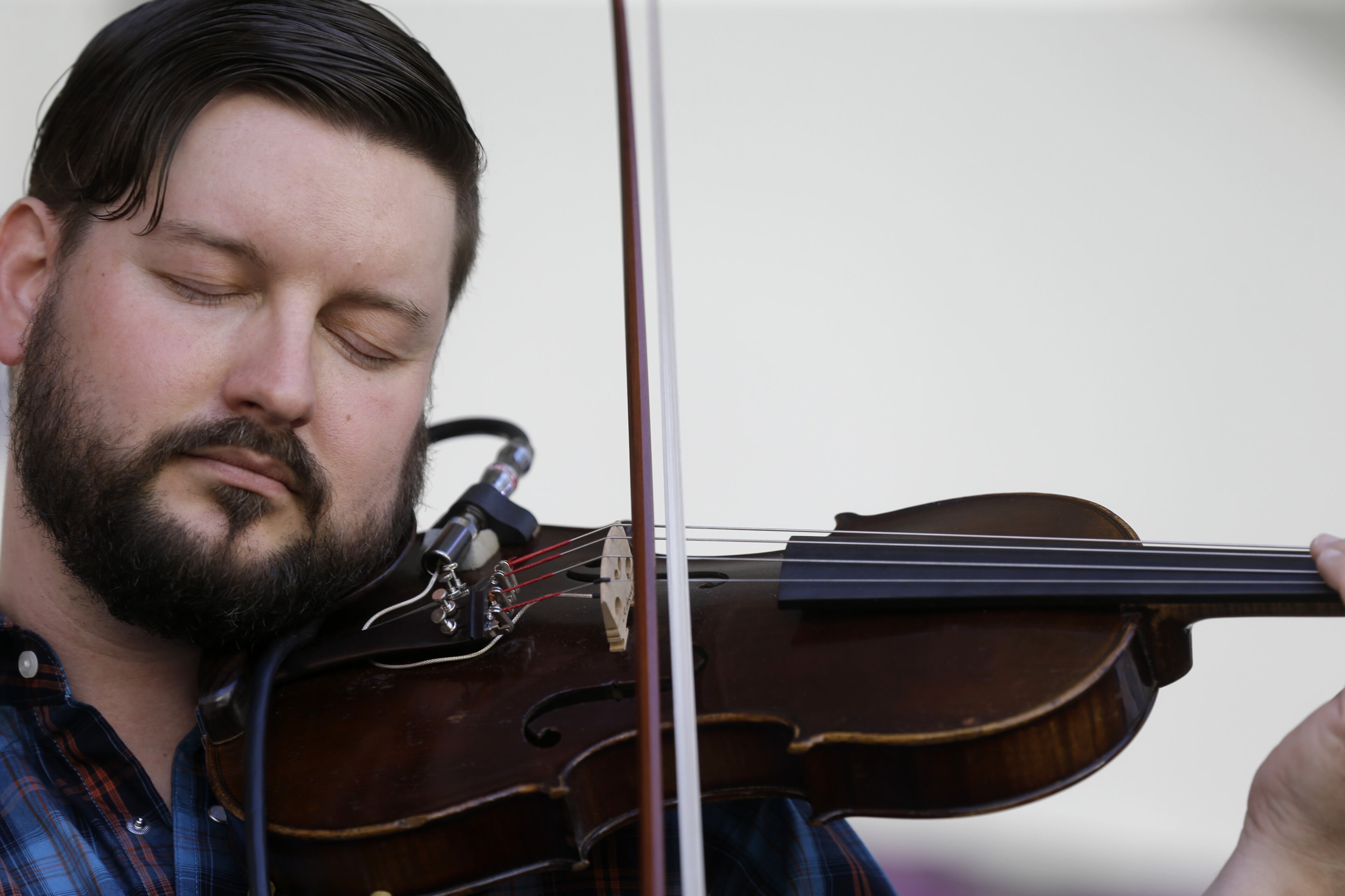 Gram Rea, of The Mulligan Brothers, plays the violin as the band performs at the New Orleans Jazz and Heritage Festival in New Orleans, Sunday, May 3, 2015. (AP Photo/Gerald Herbert)