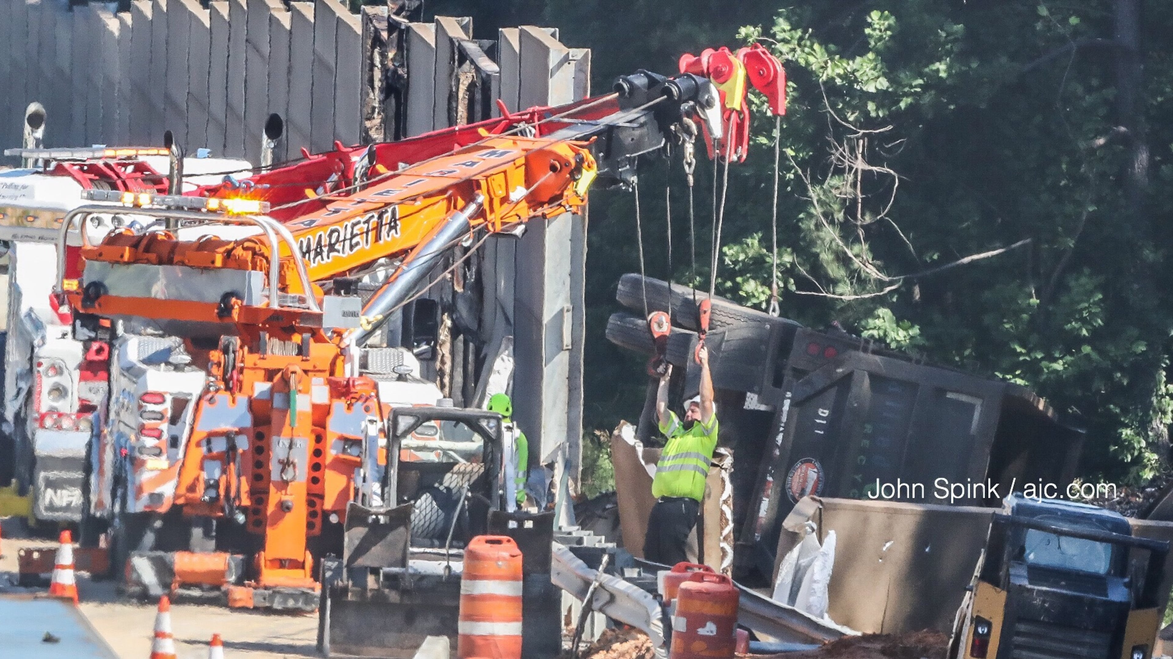 A sound barrier on I-75N is installed after officials said a tractor-trailer went through the wall. (John Spink/AJC file)