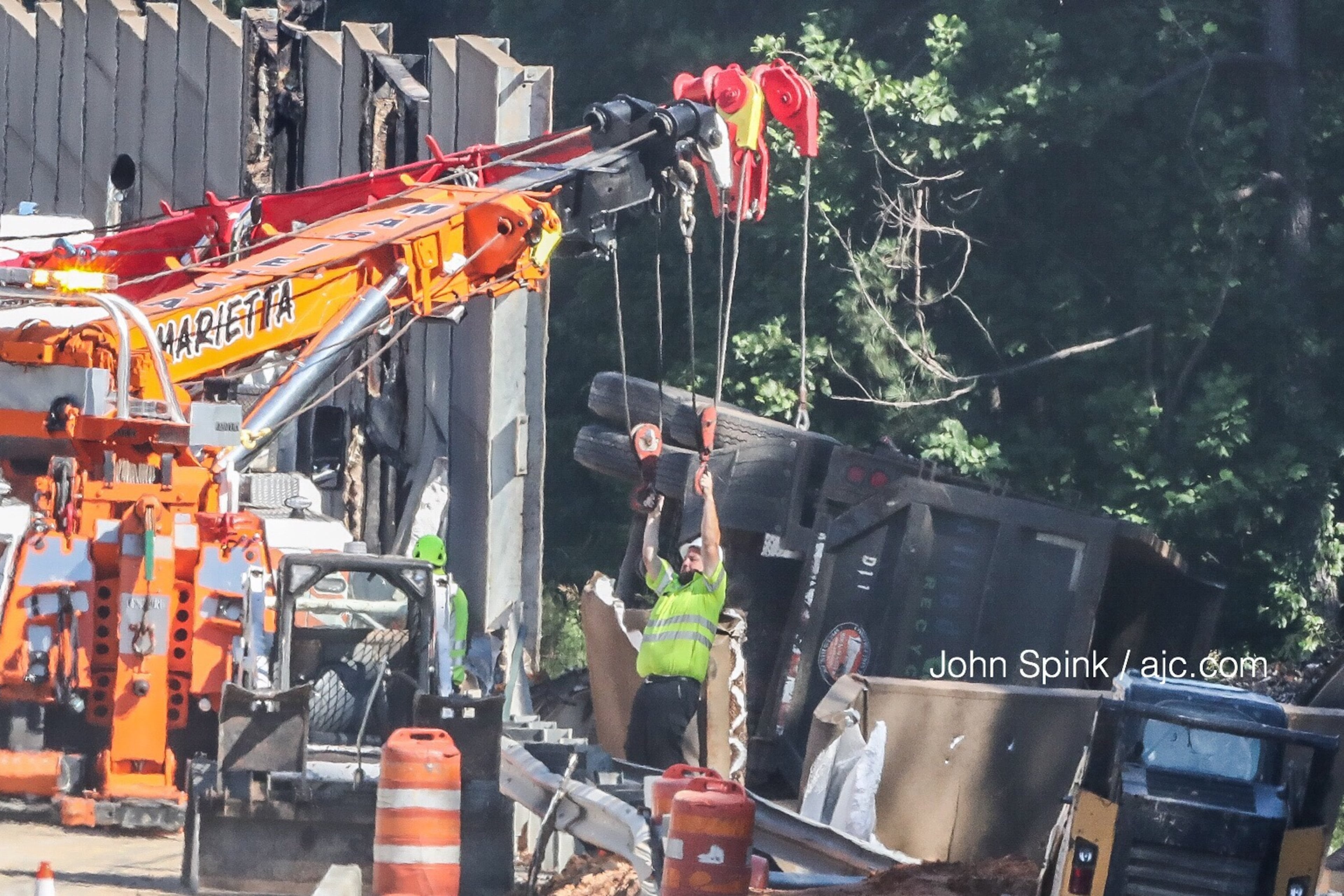 A sound barrier on I-75N is installed after officials said a tractor-trailer went through the wall. (John Spink/AJC file)