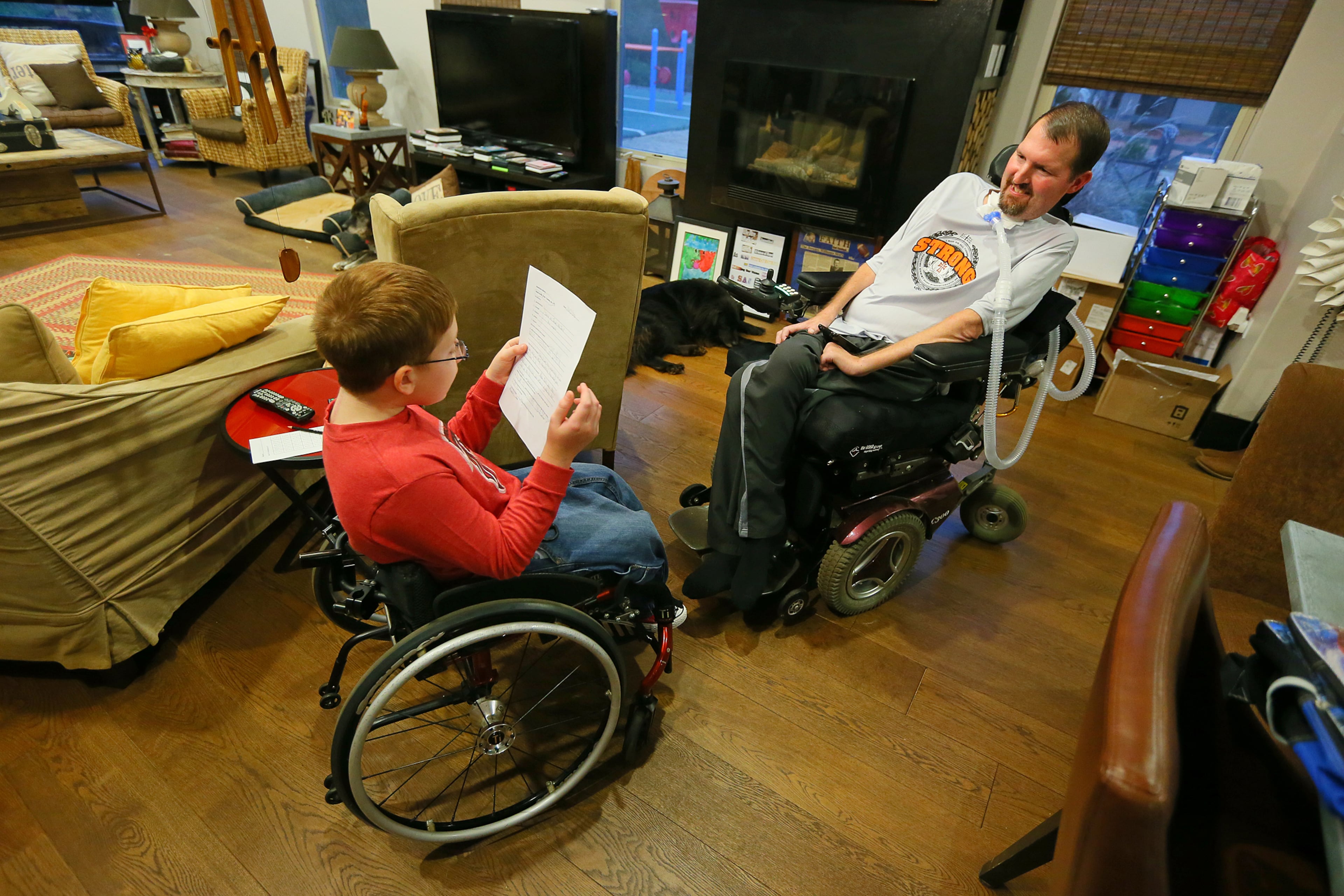 Jeremy encourages and helps his son Jacob, 9, with his third-grade homework after school.
