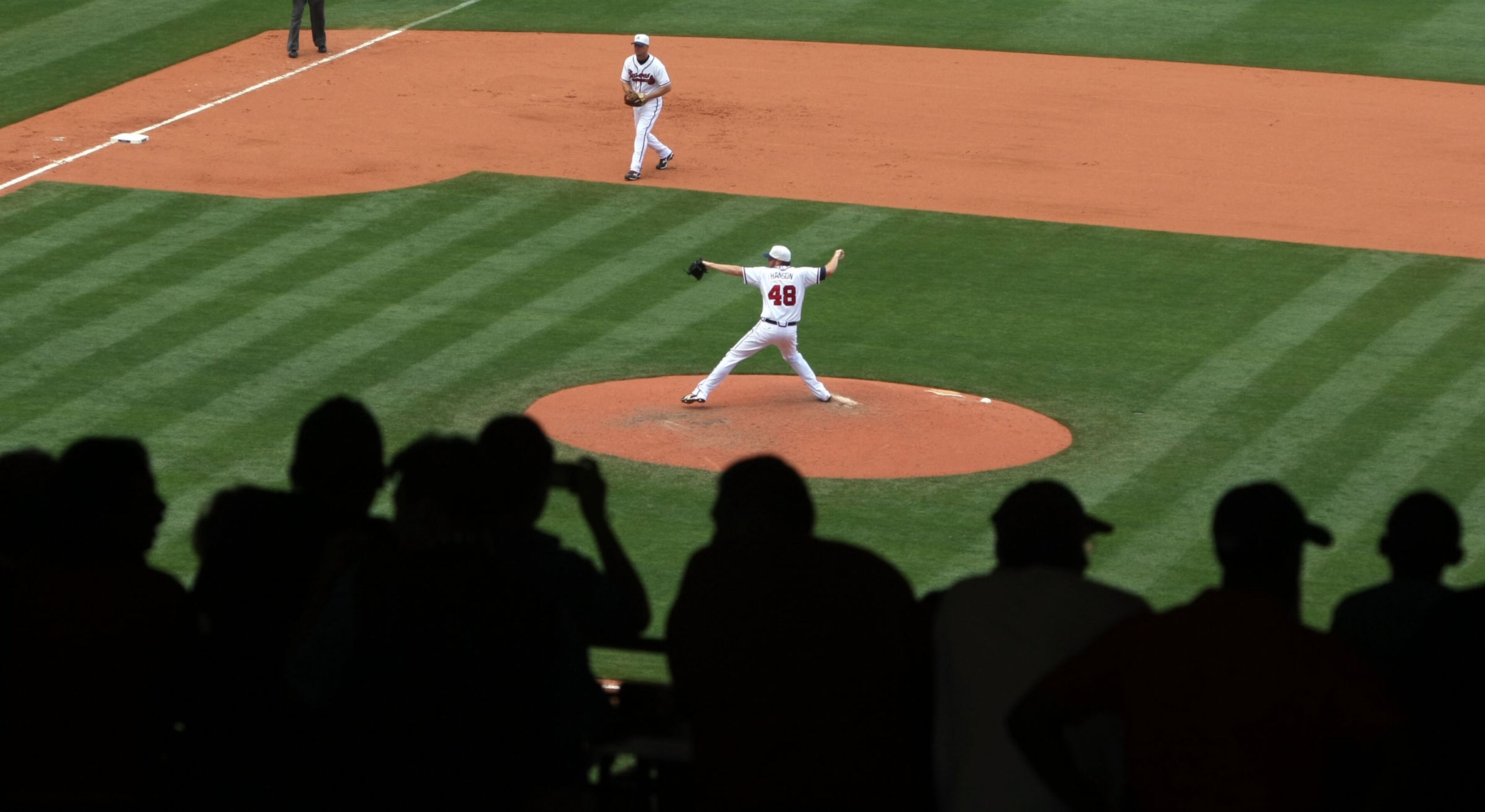 Atlanta Braves' pitcher Tommy Hanson delivers a throw as third baseman Chipper Jones is shown as a row of fans take shelter in the shade in the 6th inning of their 9-3 win over the Philadelphia Phillies on Memorial Day at Turner Field on May 31, 2010. Jason Getz, jgetz@ajc.com