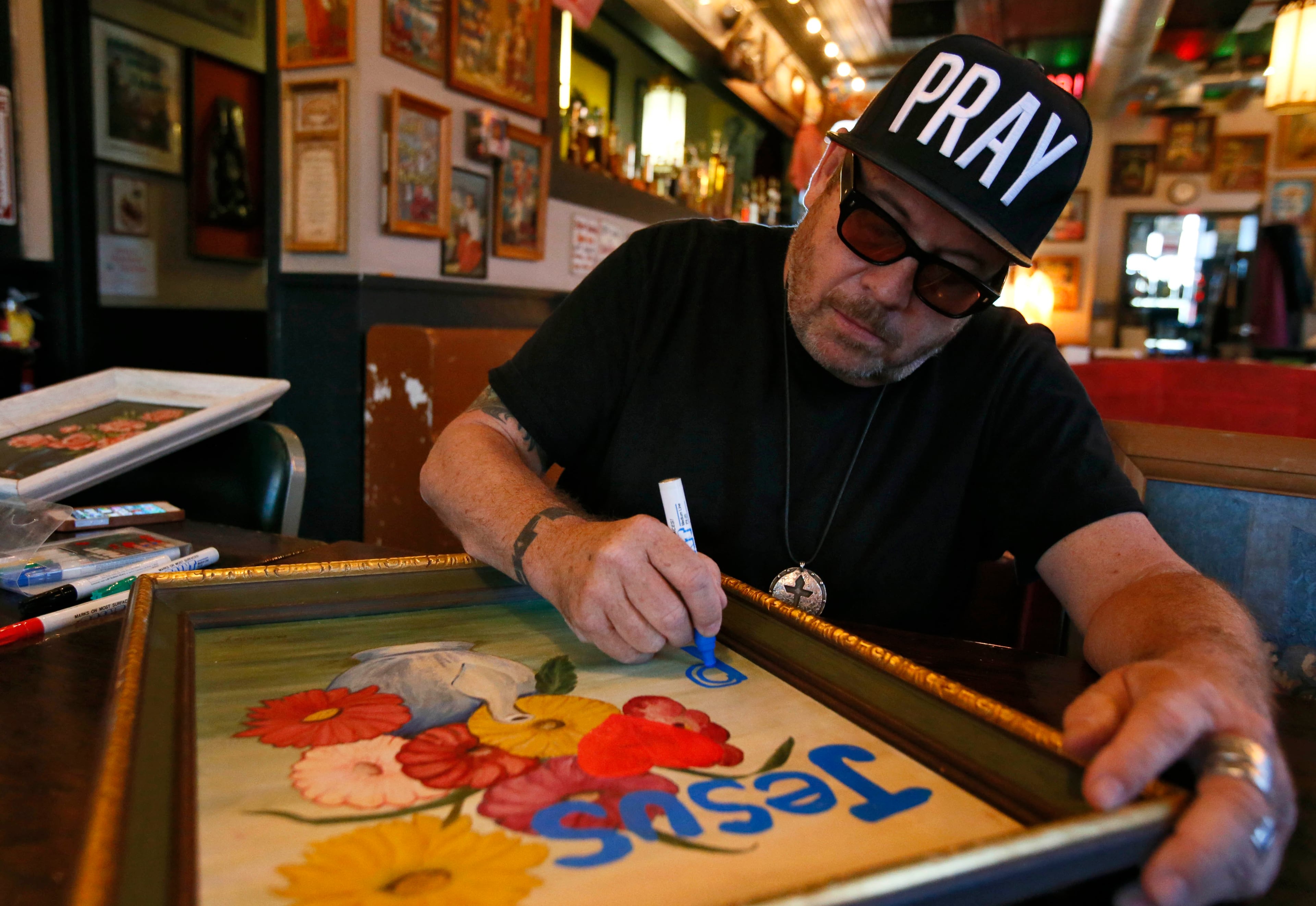 Grant Henry's artwork covers the walls of Church. BOB ANDRES / BANDRES@AJC.COM