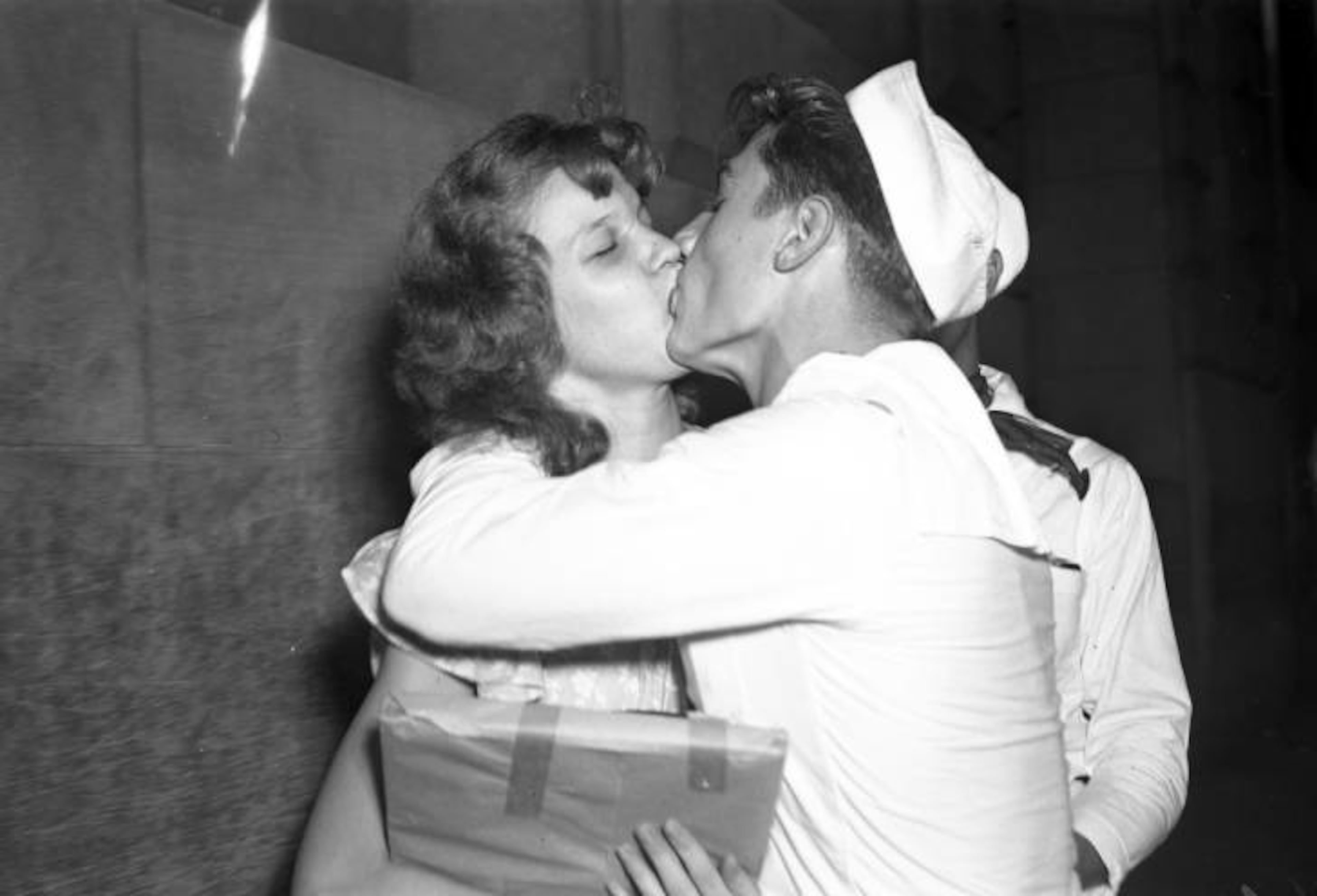 Soldier and woman embrace on V-J Day ("Victory over Japan Day"), Peachtree Street, August 14, 1945.