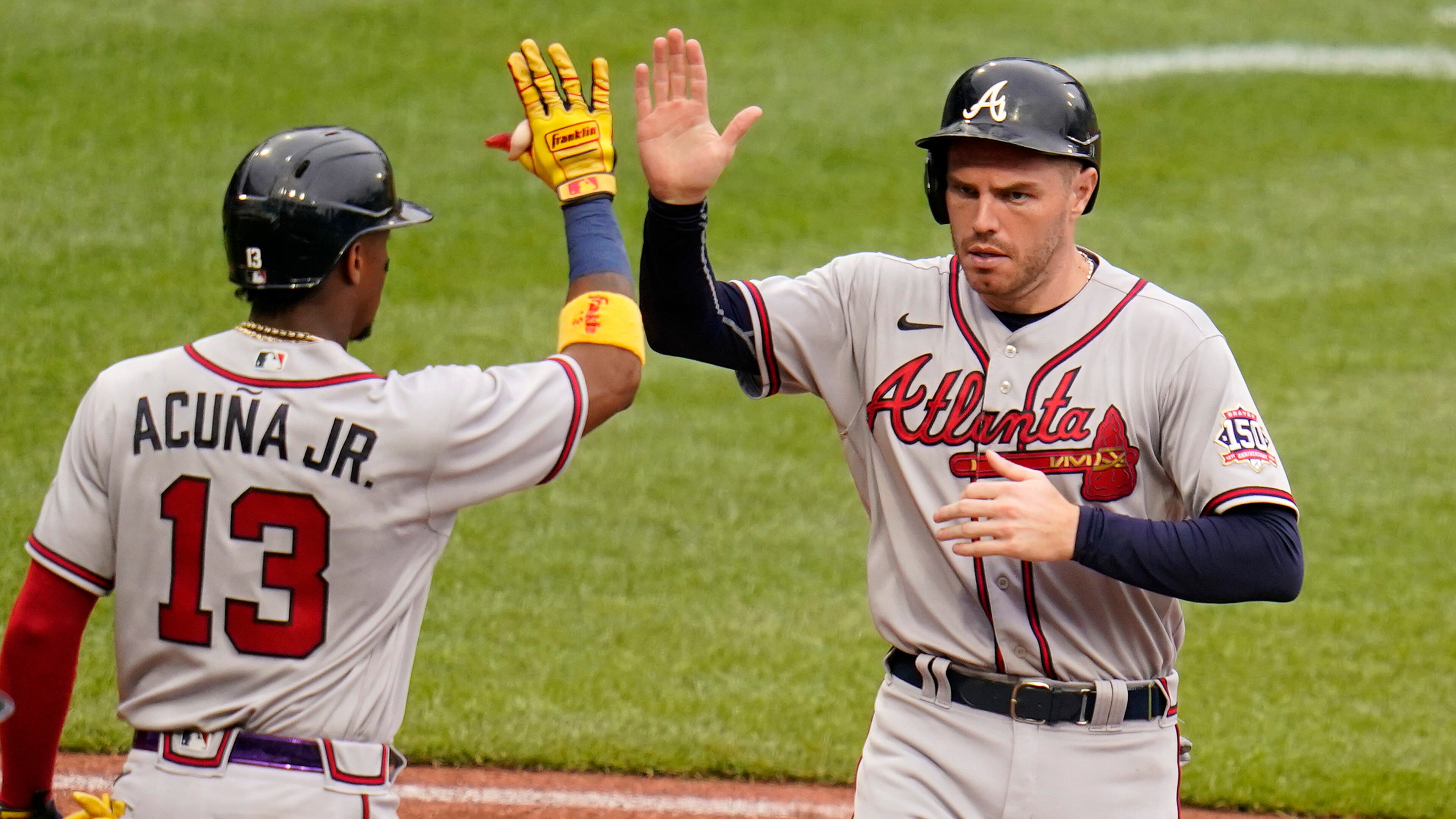 Atlanta Braves' Freddie Freeman, right, celebrates with Ronald Acuna Jr. after both scored on a double by Ehire Adrianza off Pittsburgh Pirates relief pitcher Duane Underwood Jr. during the eighth inning of a baseball game in Pittsburgh, Wednesday, July 7, 2021. (AP Photo/Gene J. Puskar)