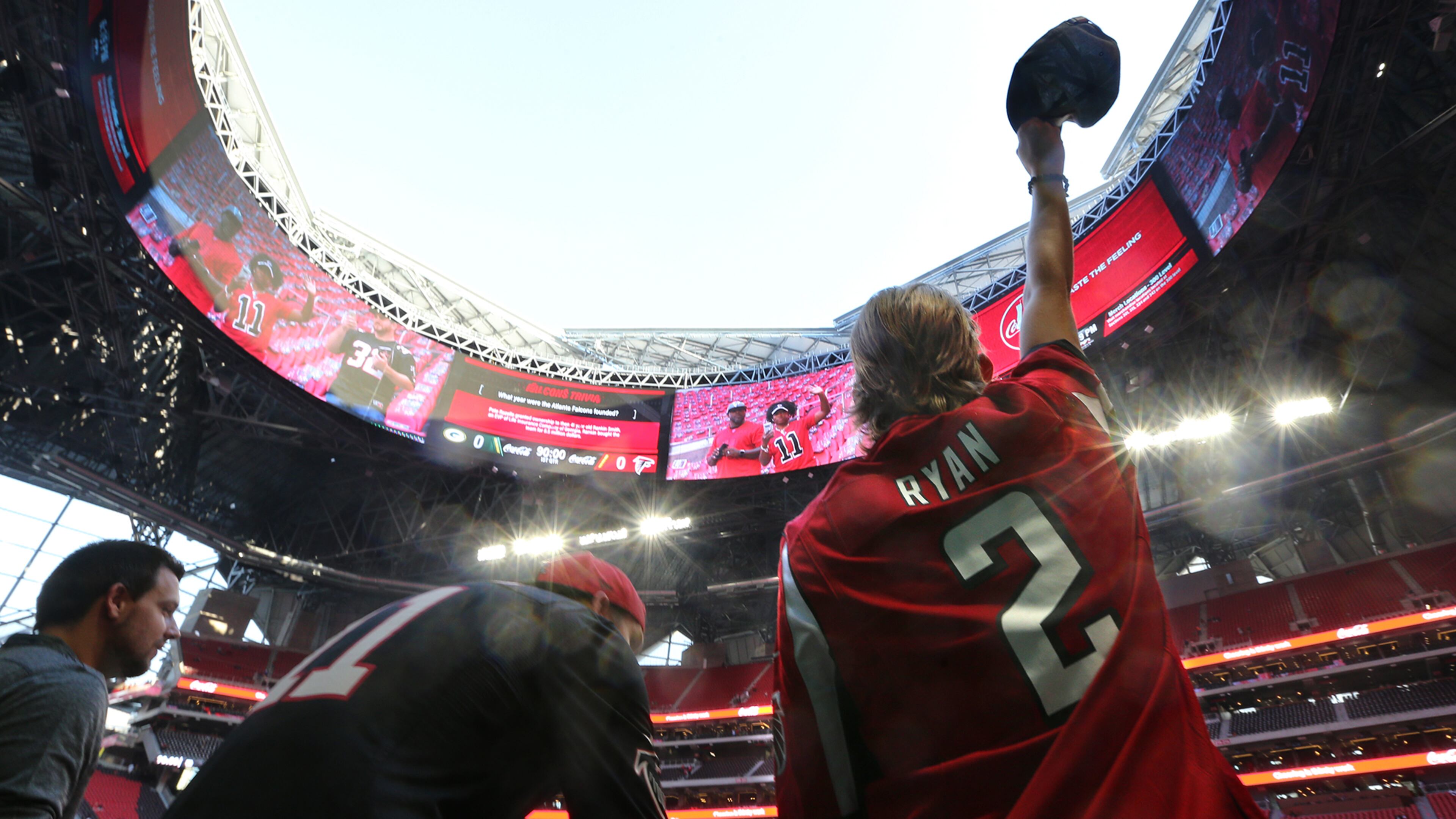 Colton Holder, of Snellville, waves his cap beneath the open roof of Mercedes-Benz Stadium before Sunday’s Falcons-Packers game.