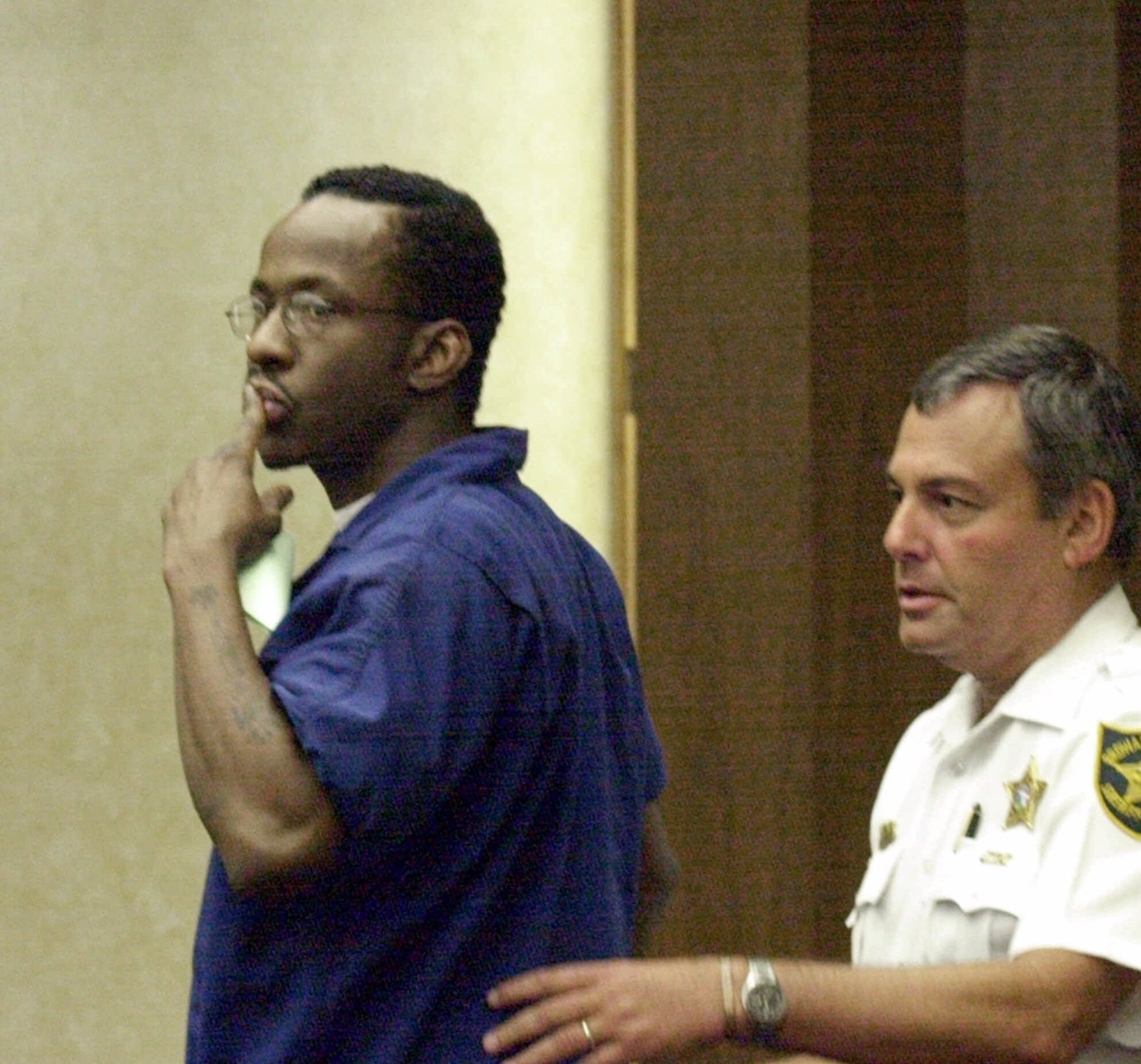 Bobby Brown throws a kiss to family members in Broward County judge Leonard Feiner's courtroom, in Fort Lauderdale, Fla . Monday, June 12, 2000 after a hearing on probation violations charge. Brown will serve a total of 75 days for the violation of his probation on a drunken driving conviction. Court Deputy Joe Rosen , right, helps Brown as he leaves the courtroom. (AP Photo/Lou Touman/Pool)