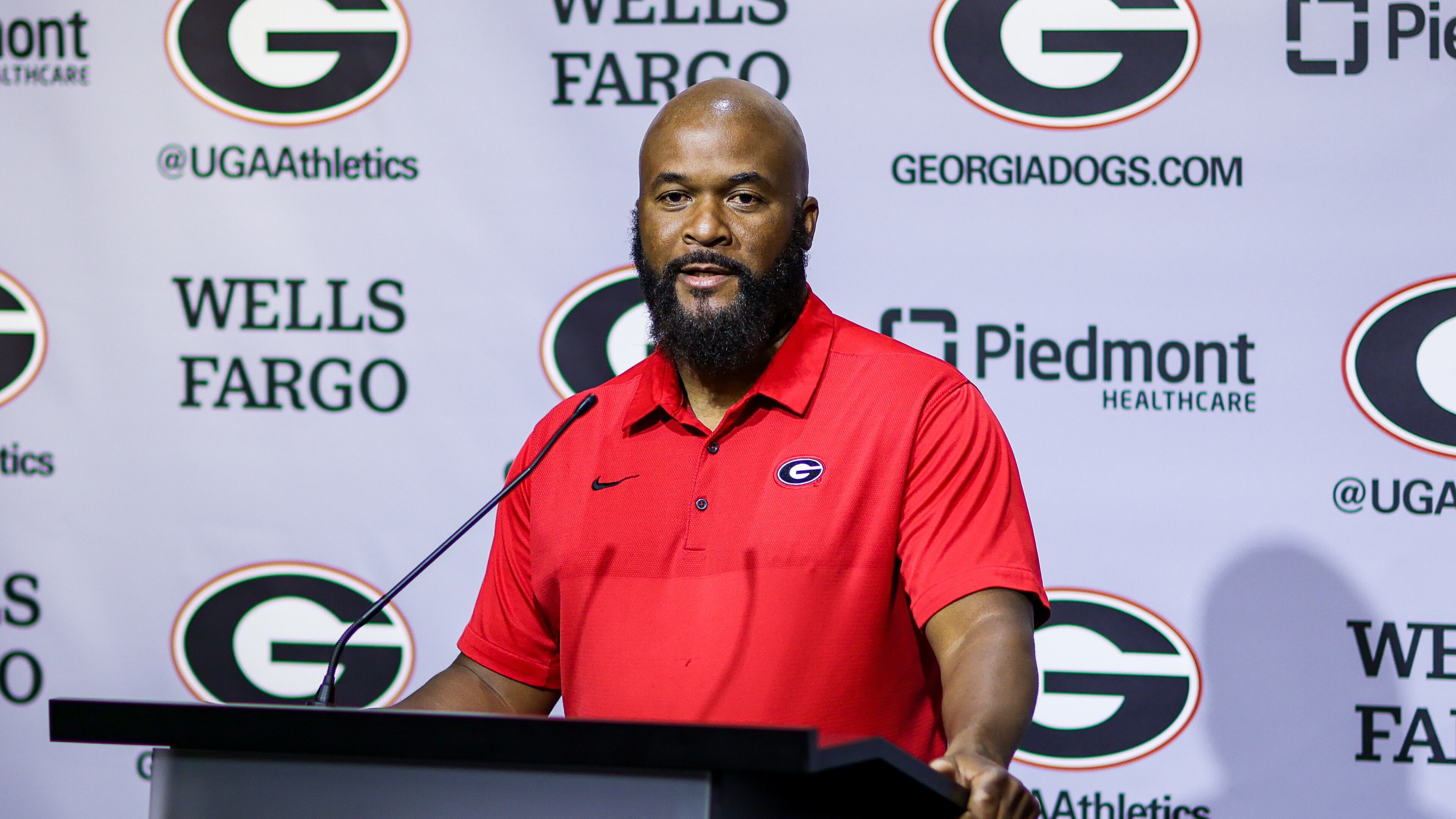 UGA running backs coach Dell McGee, here speaking to reporters at a news conference early in preseason camp, revealed Sunday that freshman Andrew Paul has been sidelined for the season with a knee injury. (Photo by Tony Walsh/UGA Athletics)