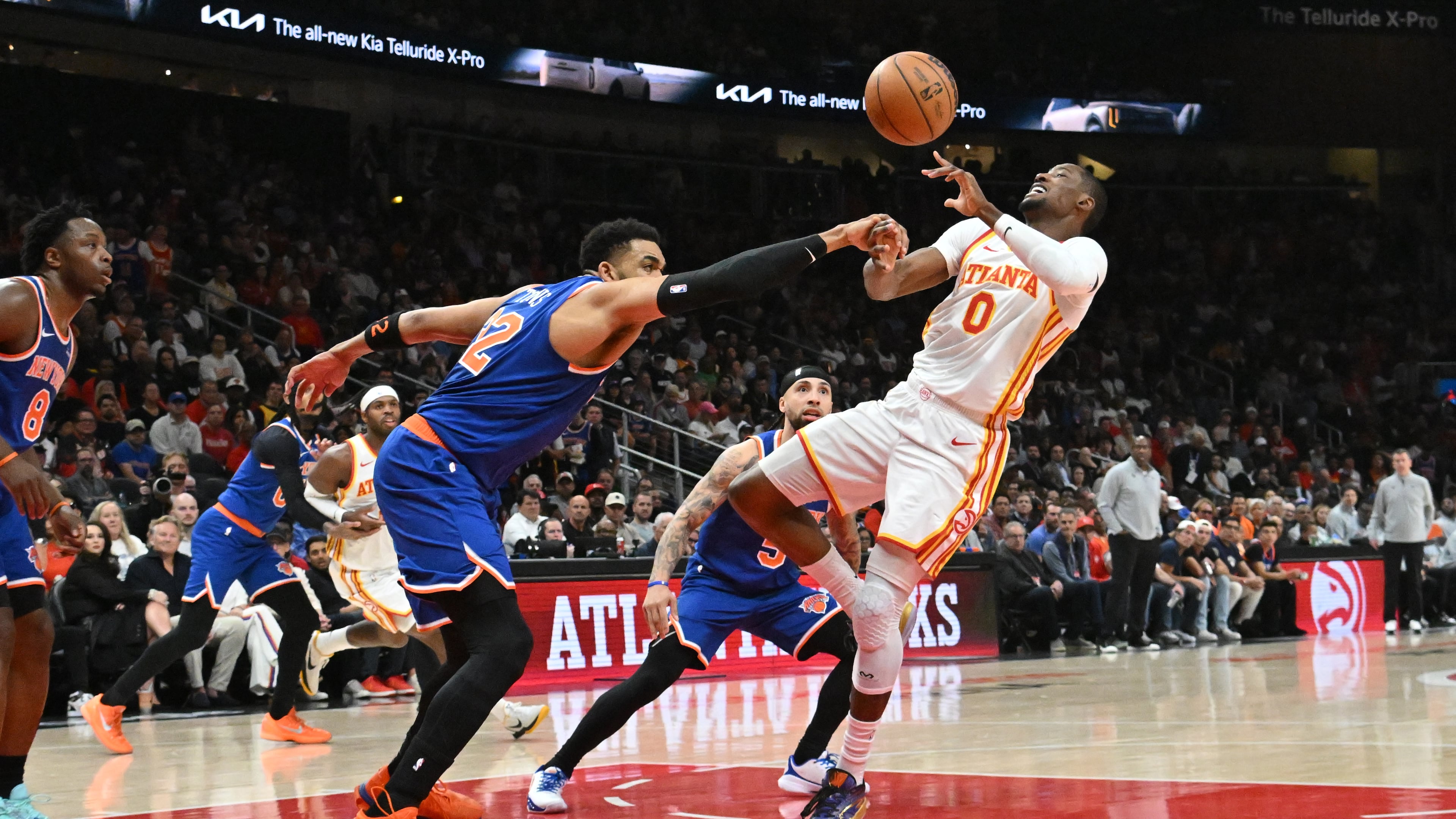 New York Knicks center/forward Karl-Anthony Towns (32) knocks the ball away from Atlanta Hawks forward Jonathan Kuminga (0) during the first half of Game 6 of a first-round NBA playoff series at State Farm Arena on Thursday, April 30, 2026, in Atlanta. (Hyosub Shin/AJC)