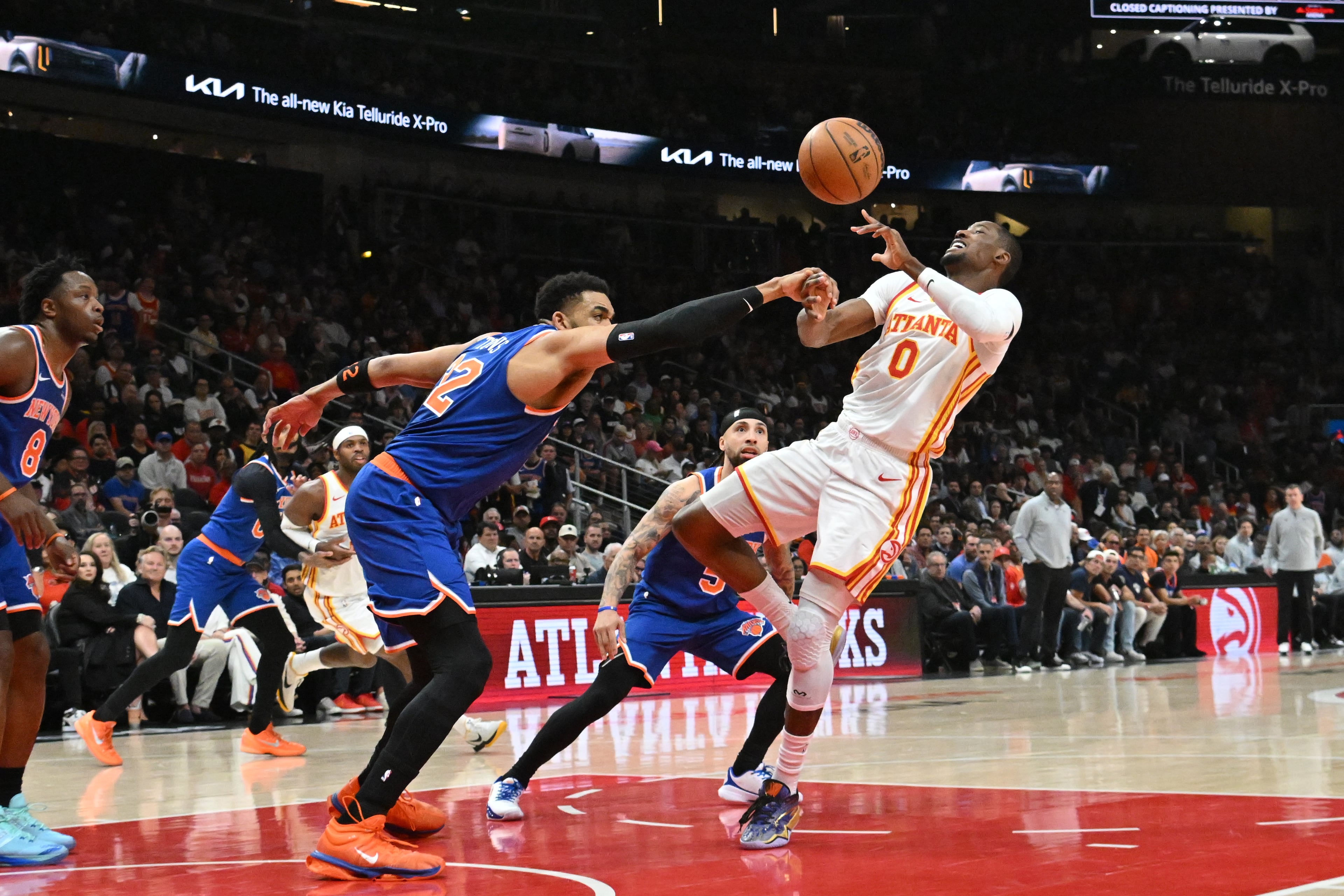 Knicks center/forward Karl-Anthony Towns (left) knocks the ball away from Hawks forward Jonathan Kuminga during the first half of Game 6 of a first-round playoff series April 30, 2026, at State Farm Arena in Atlanta. (Hyosub Shin/AJC)