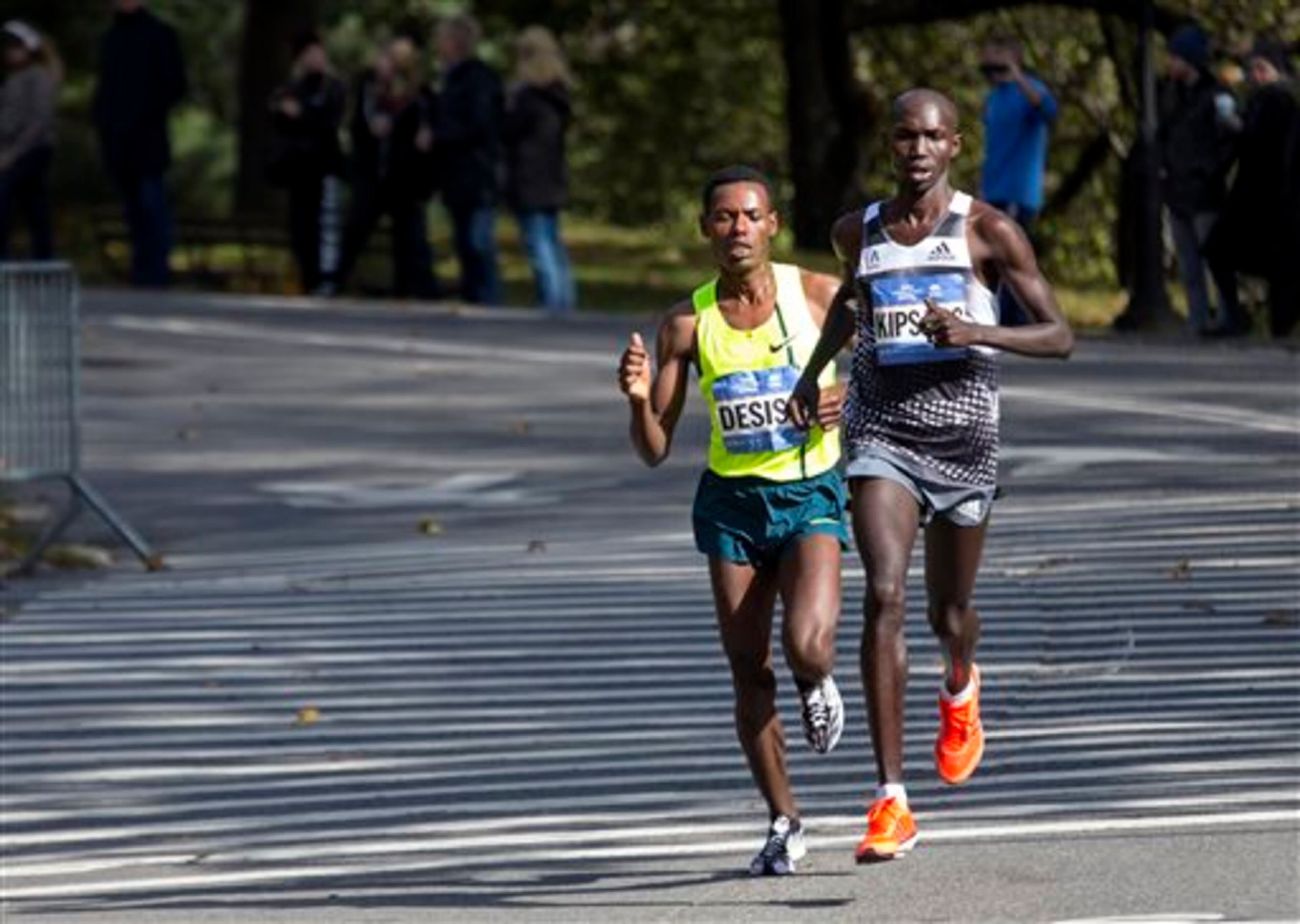 Wilson Kipsang, of Kenya, battles Lelisa Desisa, of Ethiopia, in Central Park during the final moments of the New York City Marathon in New York Sunday, Nov. 2, 2014. Kipsang went on to win. (AP Photo/Craig Ruttle)