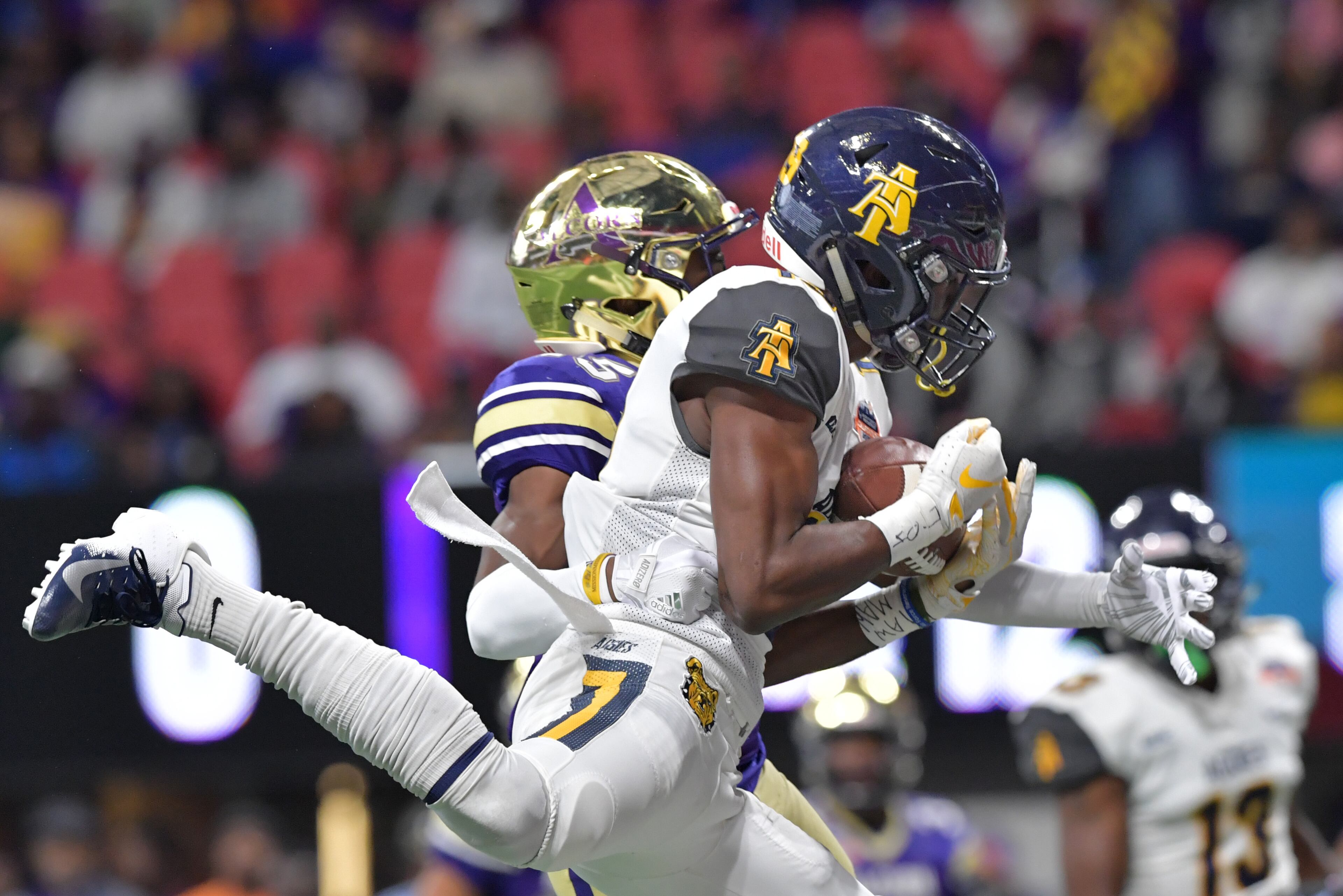 December 15, 2018 Atlanta - North Carolina A&T wide receiver Zachary Leslie (19) makes a touchdown pass over Alcorn State defensive back Javen Morrison (45) during the first half of the 2018 Celebration Bowl at Mercedes-Benz Stadium on Saturday, December 15, 2018. HYOSUB SHIN / HSHIN@AJC.COM