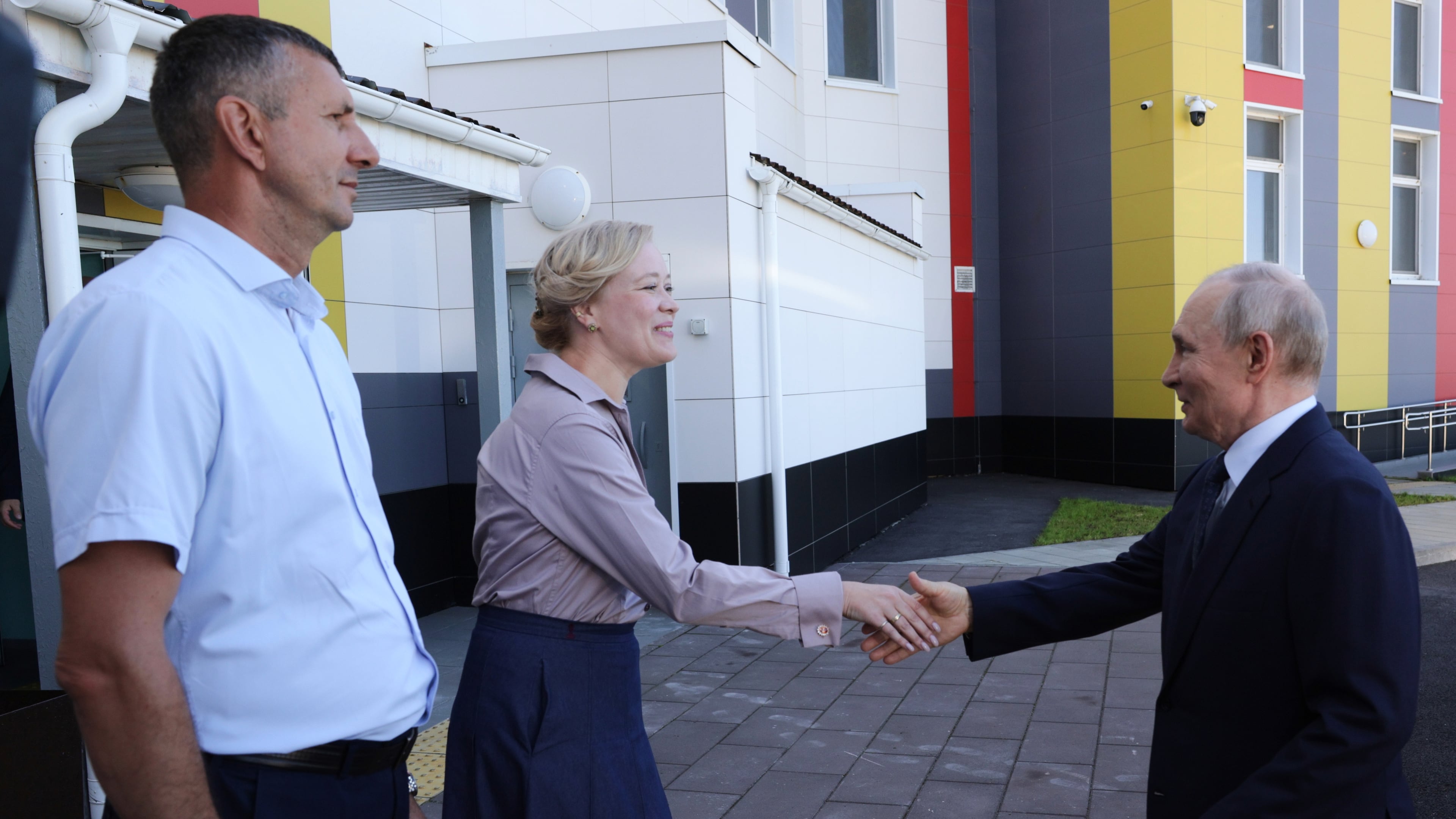 Russian President Vladimir Putin, right, visits the Secondary School named after the Hero of Russia Eduard Norpolov in Kurilsk on the Iturup Island, the largest of the Kuril Islands of Russia's fareast, on Thursday, Aug. 13, 2026. (Gavriil Grigorov, Sputnik, Kremlin Pool Photo via AP)