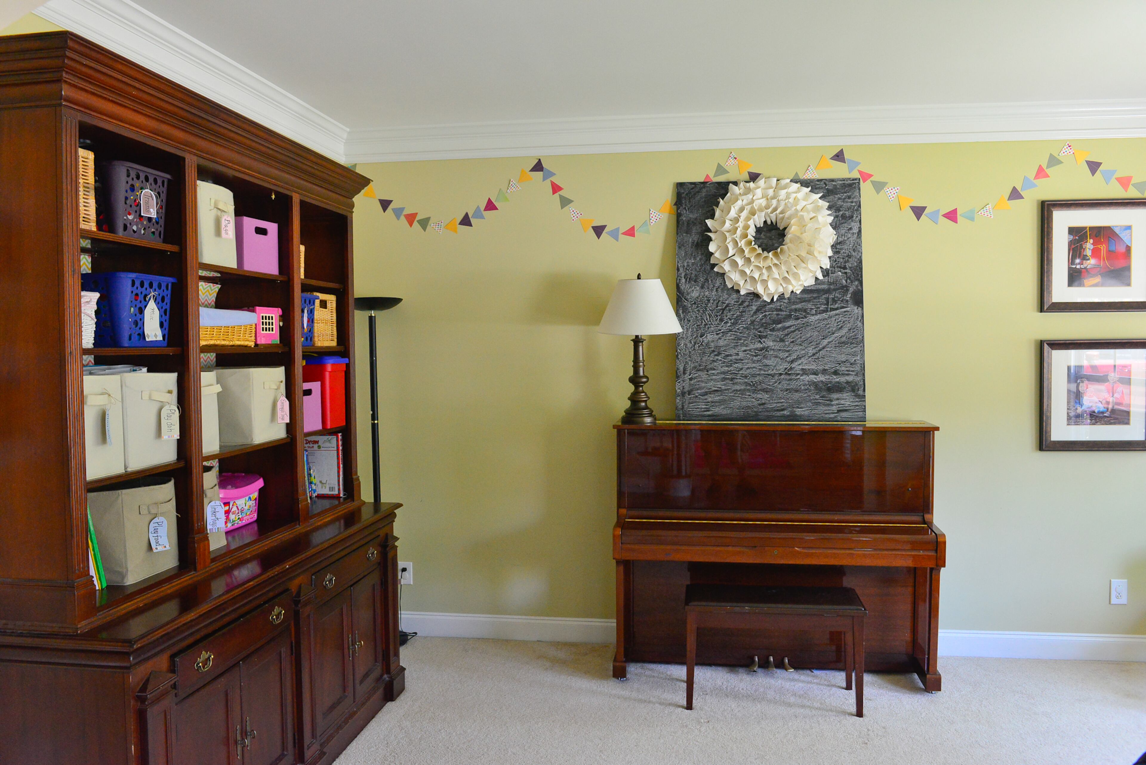 The playroom has a large bookshelf, from the homeowners' parents, that helps keep the room organized. The piano belonged to homeowner Yuni Min when she was a child, and now her children play it. The room has a large bay window, one of Yuni's favorite architectural features in her Cumming home. Christopher Oquendo/AJC FILE