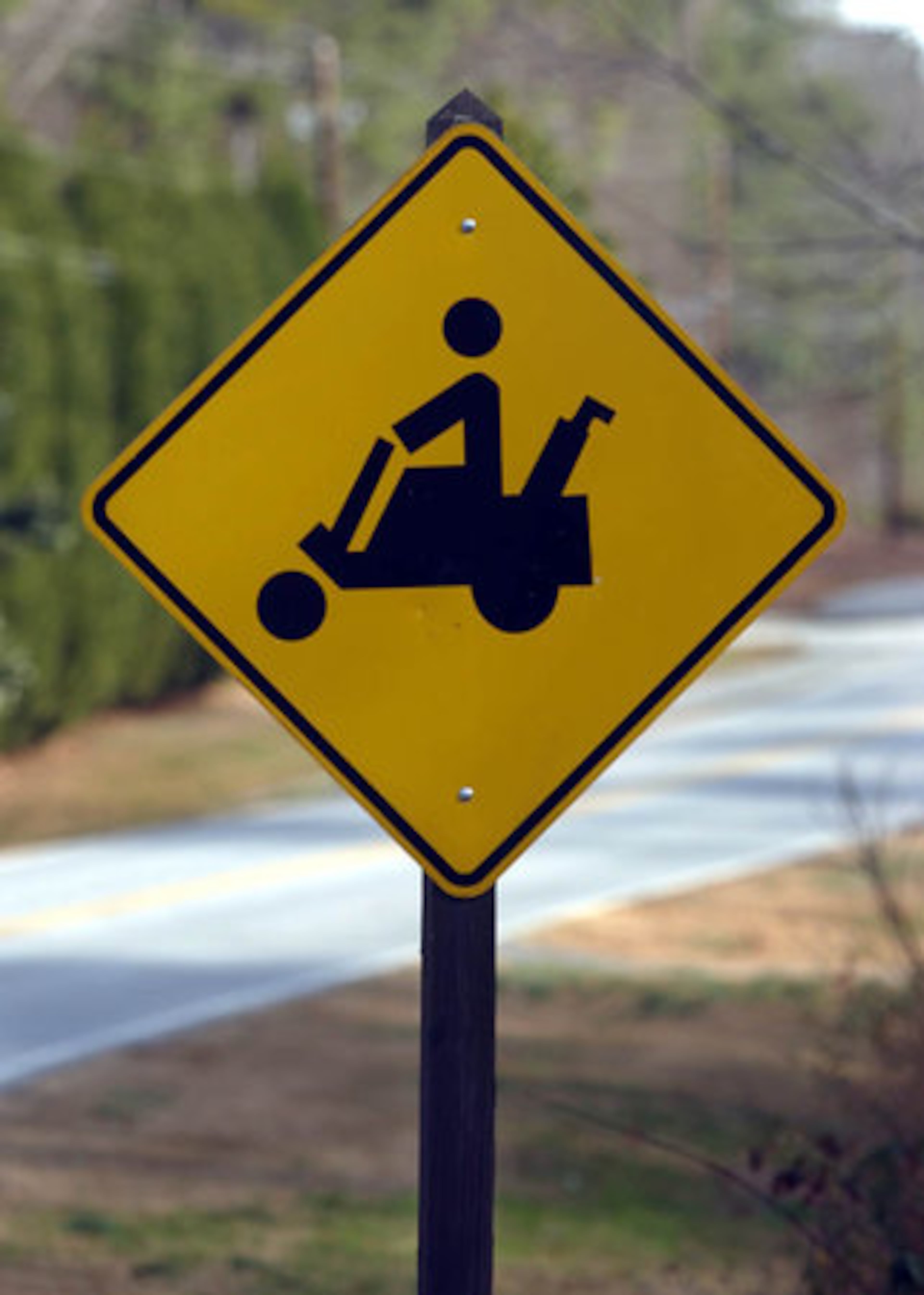 A golf cart crossing sign in Peachtree City shows how popular the vehicles are. Golf Carts are a primary form of transportation in a city that has developed its business and residential areas around golf cart pathways.