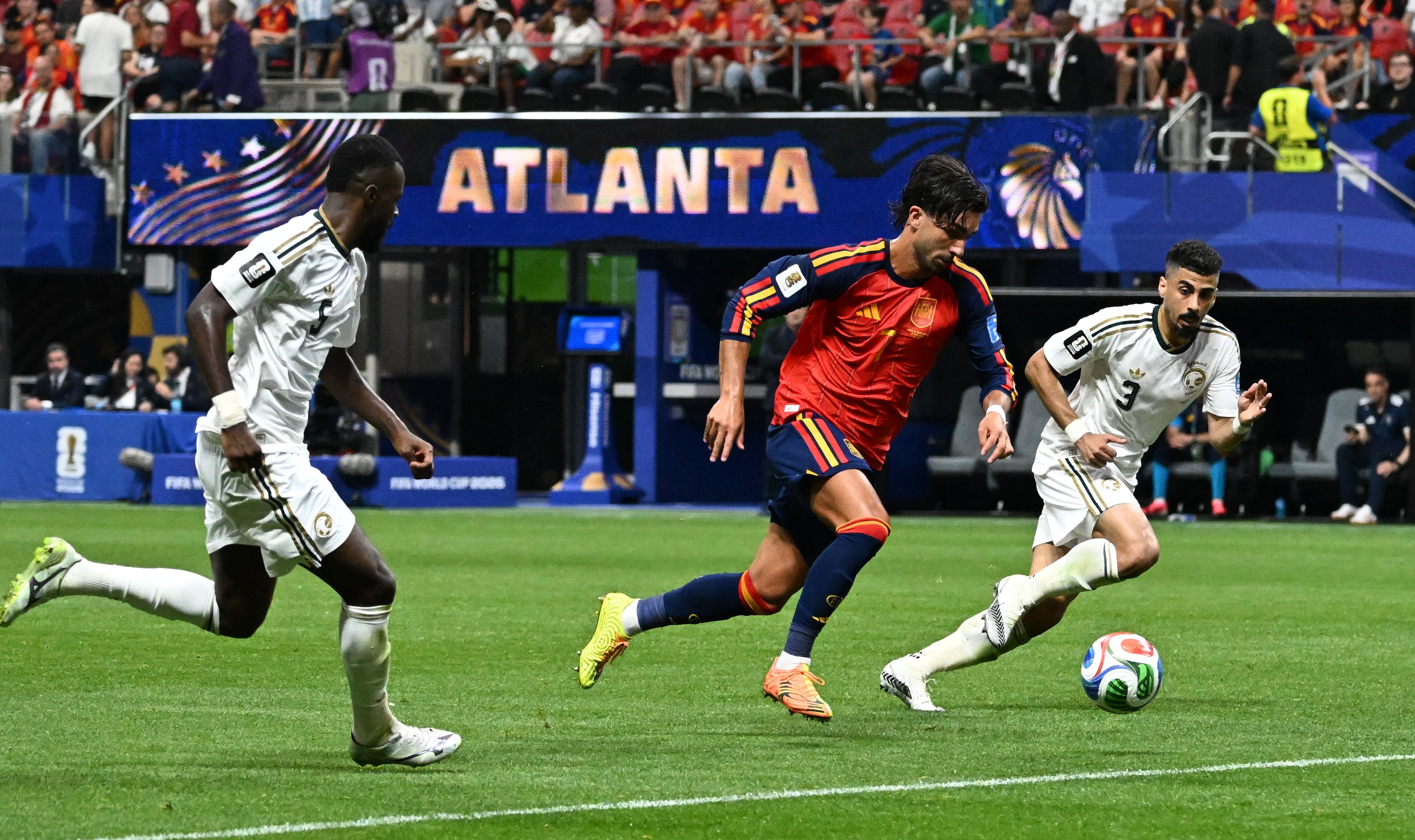 Spain's Ferran Torres (center) runs between Saudi Arabia's Hassan Al-Tambakti (left) and Ali Lajami during the second half of the Spain vs. Saudi Arabia World Cup match Sunday, June 21, 2026, at Atlanta Stadium. (Hyosub Shin/AJC)