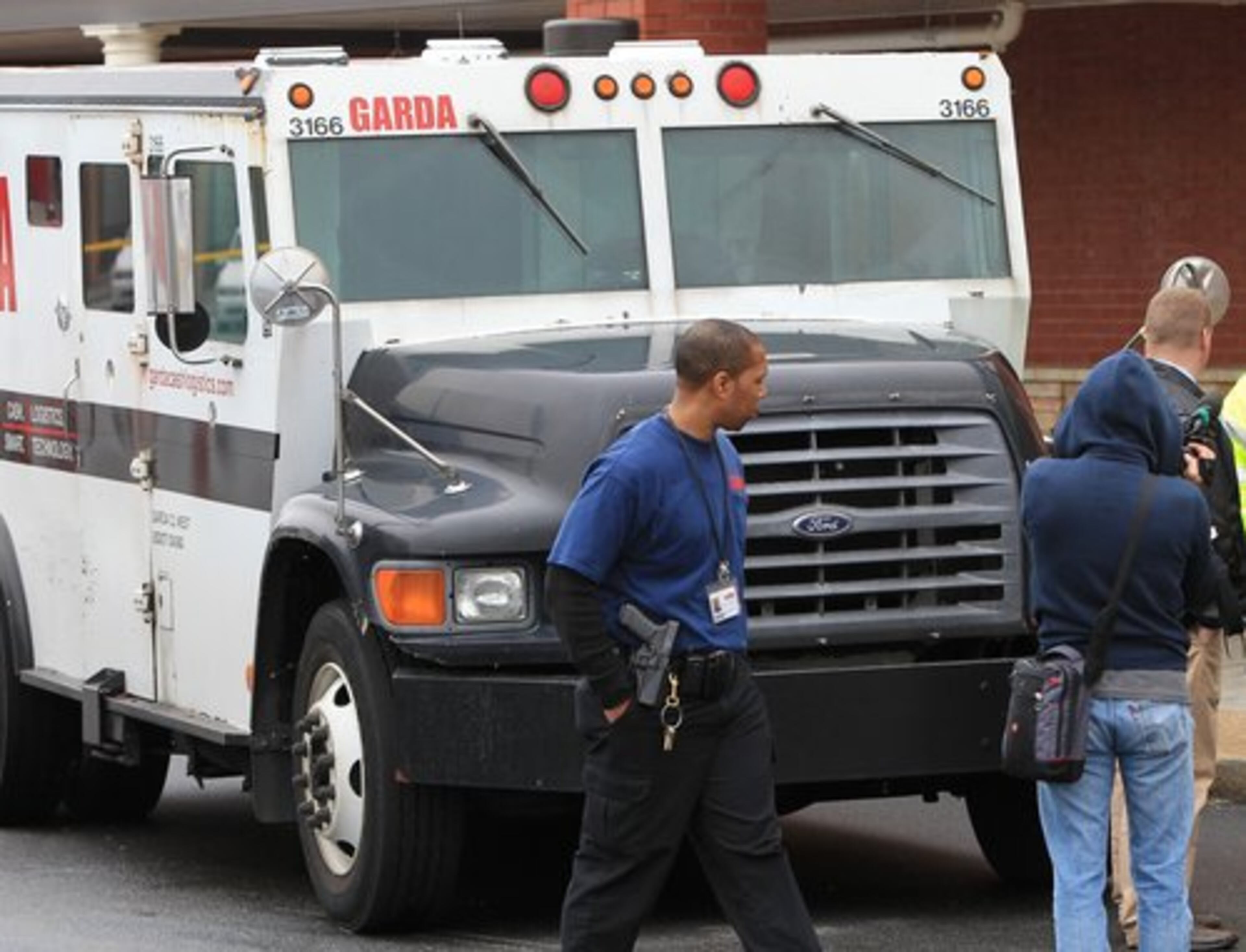 Police and investigators work the scene where two men killed a guard in a daring armored car robbery at the Kroger on Lavista Road at North Druid Hills. The courier, who authorities have not identified, was shot as he walked to his vehicle, which was parked at the curb. He had just serviced the Kroger in the 2200 block of Lavista Road.