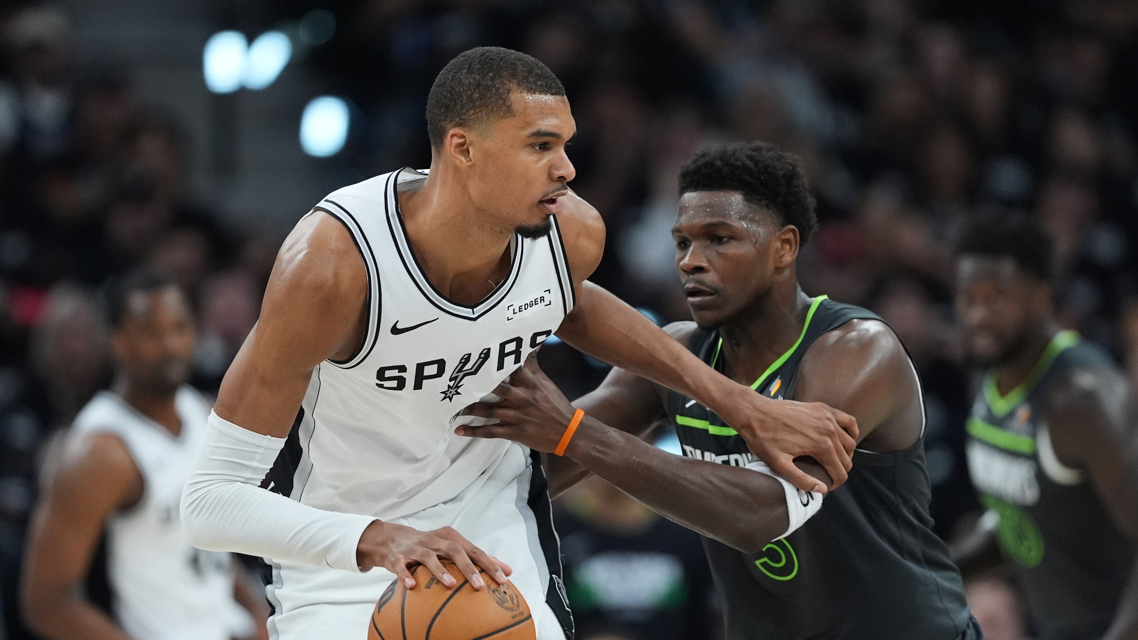 San Antonio Spurs forward Victor Wembanyama (1) drives against Minnesota Timberwolves guard Anthony Edwards (5) during the first half in Game 2 of a second-round NBA playoffs basketball series in San Antonio, Wednesday, May 6, 2026. (AP Photo/Eric Gay)