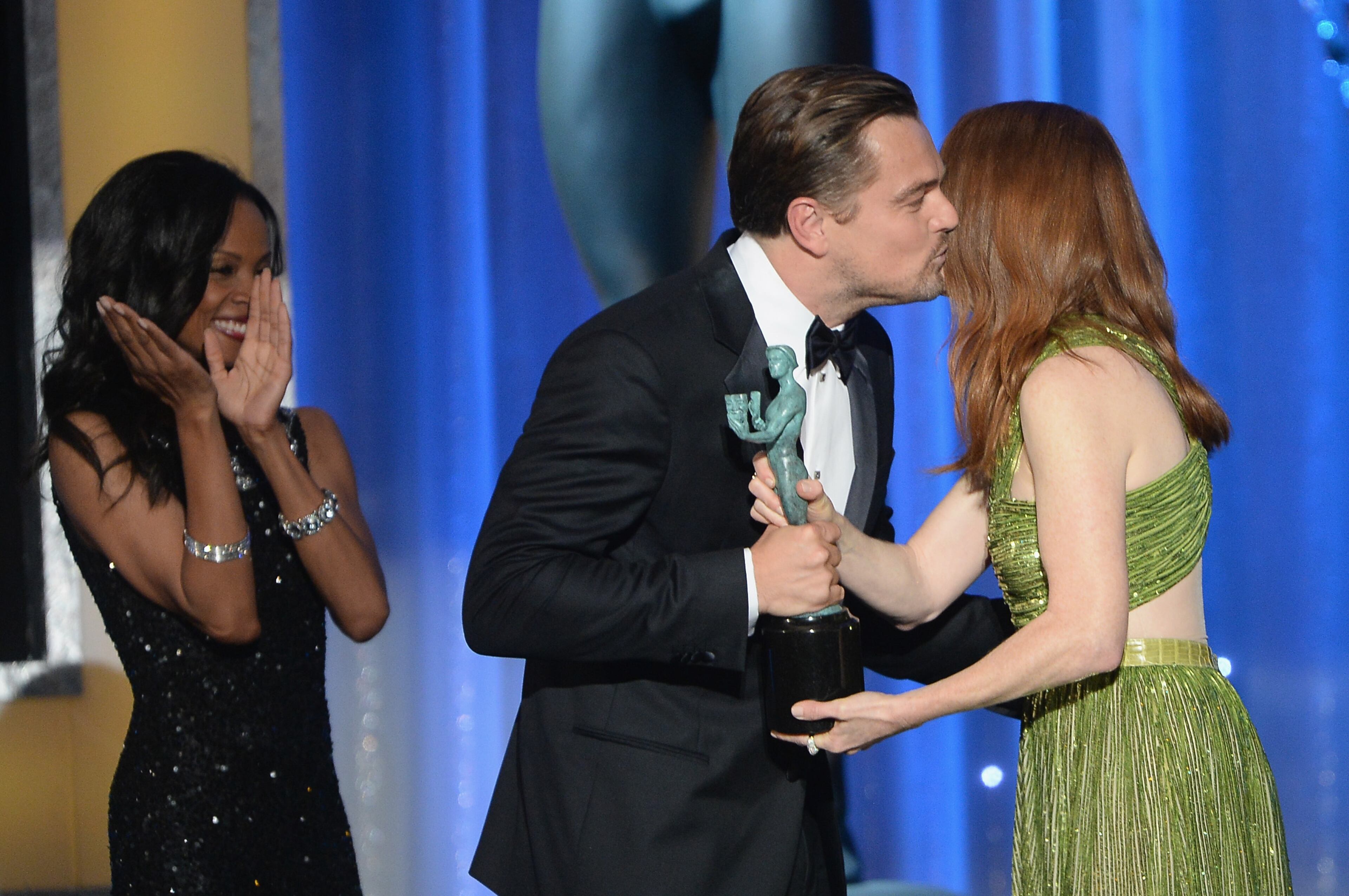 LOS ANGELES, CA - JANUARY 30: Actor Leonardo DiCaprio (C) accepts Outstanding Performance by a Male Actor in a Leading Role for 'The Revenant' from actress Julianne Moore (R) onstage during the 22nd Annual Screen Actors Guild Awards at The Shrine Auditorium on January 30, 2016 in Los Angeles, California. (Photo by Kevork Djansezian/Getty Images)
