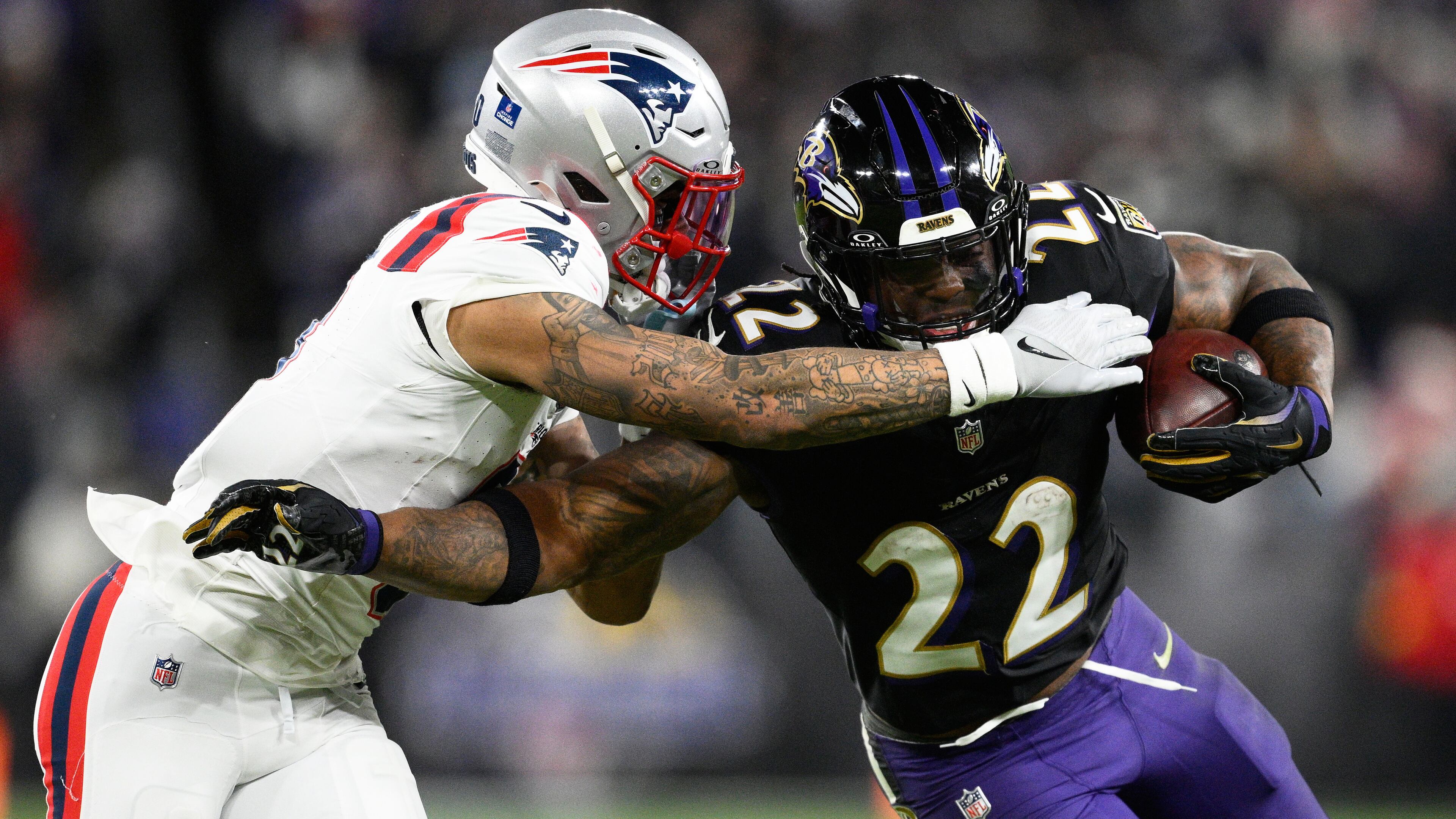 FILE - Baltimore Ravens running back Derrick Henry (22) runs against New England Patriots cornerback Christian Gonzalez during the second half of an NFL football game, Dec. 21, 2025, in Baltimore. (AP Photo/Nick Wass, File)