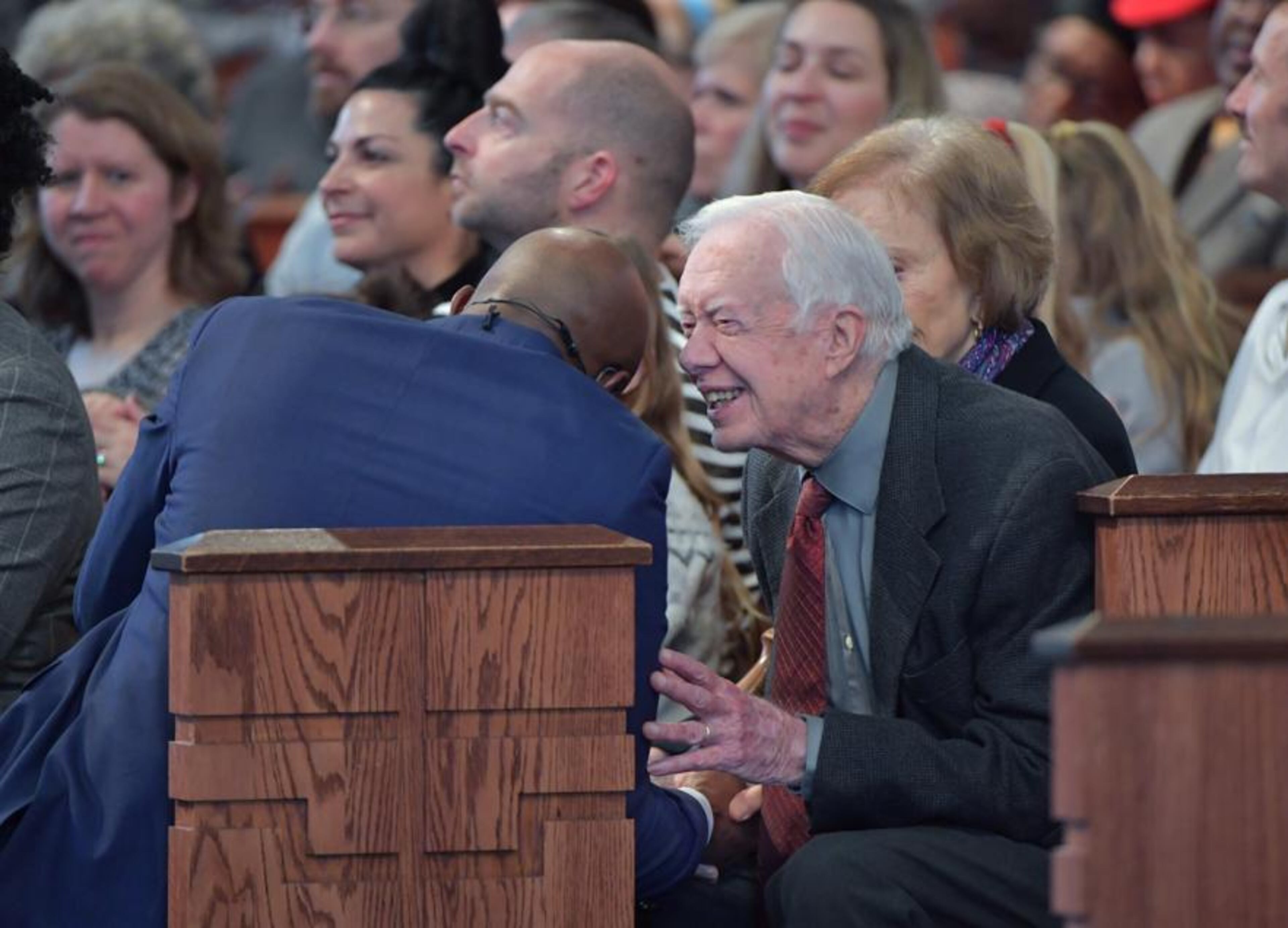 Former President Jimmy Carter talks to the Rev. Raphael Warnock, pastor of Ebenezer Baptist Church, during the Sunday morning service on December 30, 2018. The Carter family attended its final Sunday church service of 2018 at the historic Atlanta church. (Photo: HYOSUB SHIN / HSHIN@AJC.COM)