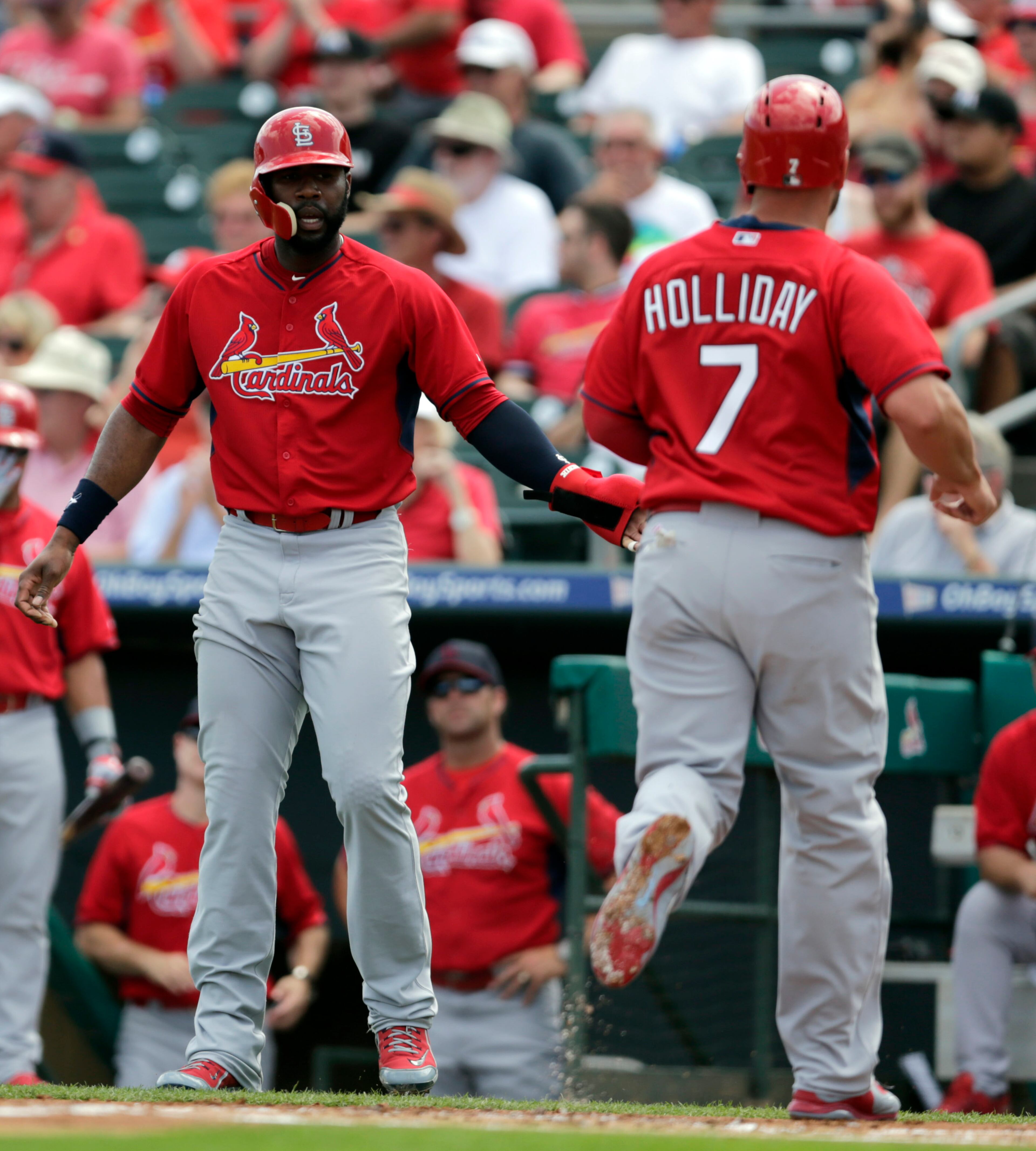 St. Louis Cardinals' Jason Heyward, left, and Matt Holliday celebrate during an exhibition game. (AP Photo/Jeff Roberson)