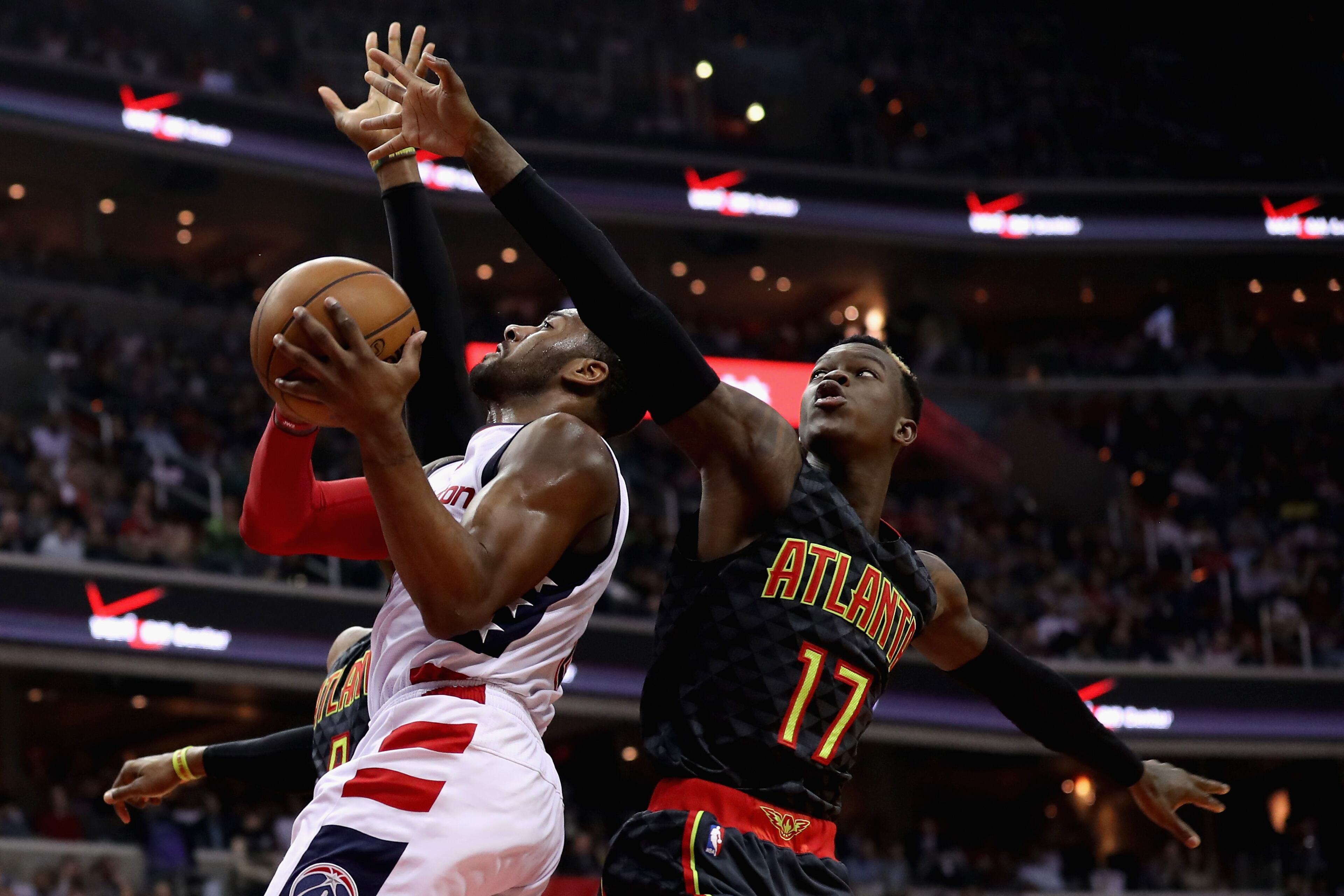 WASHINGTON, DC - APRIL 19: John Wall #2 of the Washington Wizards puts up a shot in front of Dennis Schroder #17 of the Atlanta Hawks in Game Two of the Eastern Conference Quarterfinals during the 2017 NBA Playoffs at Verizon Center on April 19, 2017 in Washington, DC. NOTE TO USER: User expressly acknowledges and agrees that, by downloading and or using this photograph, User is consenting to the terms and conditions of the Getty Images License Agreement. (Photo by Rob Carr/Getty Images)