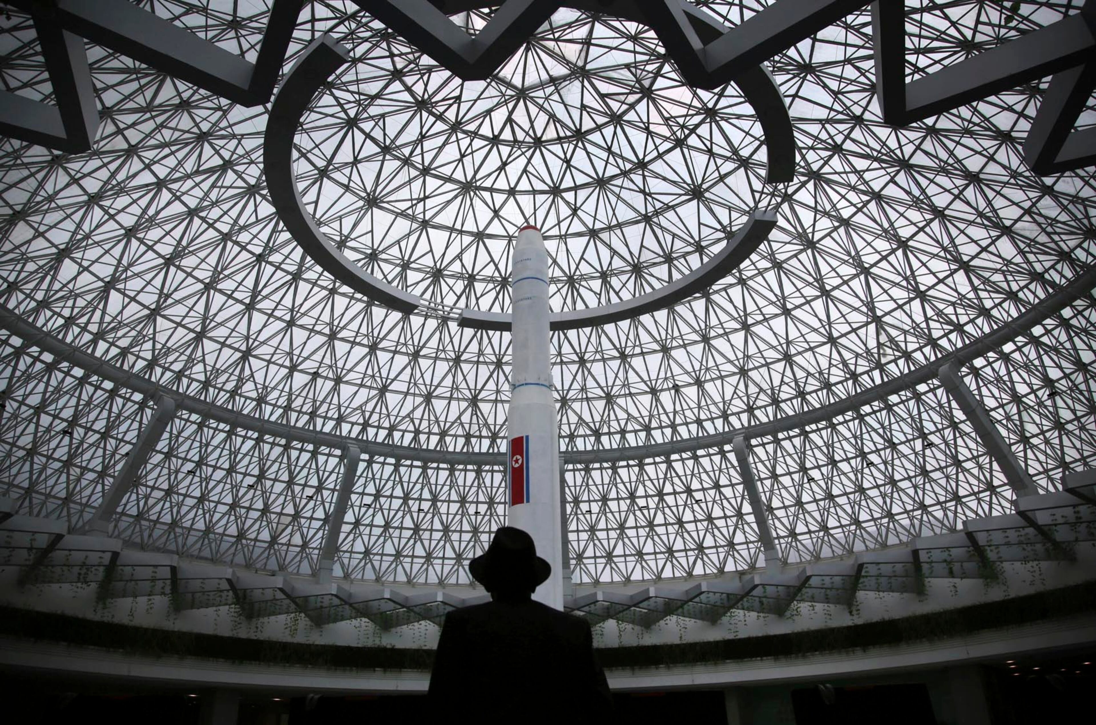 An elderly North Korean man is silhouetted against a model of the Unha 3, a space launch vehicle, displayed at the Sci-Tech Complex Monday, April 17, 2017, in Pyongyang, North Korea. Tensions have spiked in recent weeks over North Korea's advancing nuclear technology and missile arsenal. But in Pyongyang, where war would mean untold horrors, where neighborhoods could be reduced to rubble and tens of thousands of civilians could be killed, few people seem to care much at all. (AP Photo/Wong Maye-E)