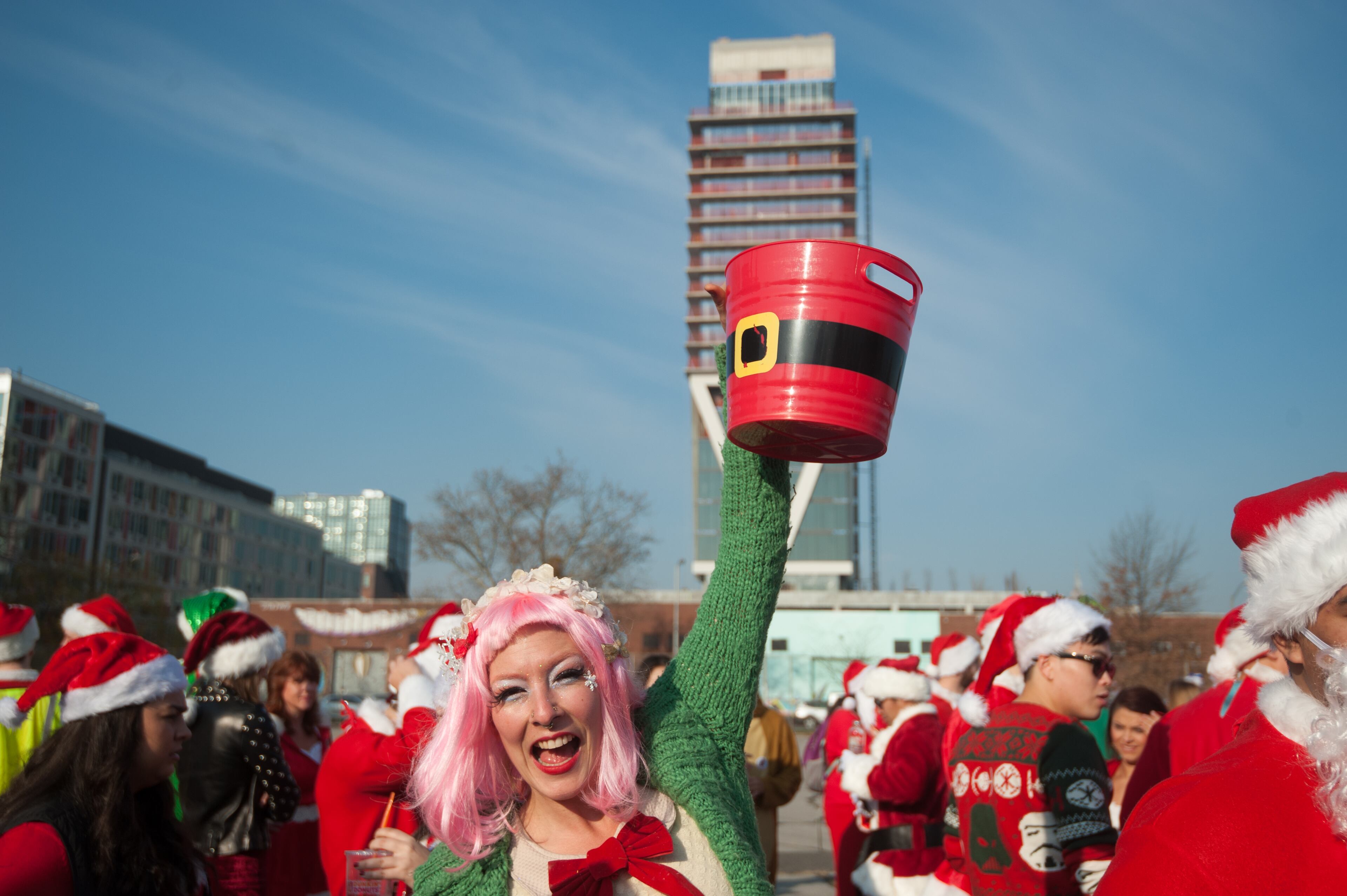 NEW YORK, NY - DECEMBER 12: A woman dressed as a Santa's elf collects donations before the start of the annual SantaCon pub crawl December 12, 2015 in the Brooklyn borough of New York City. Hundreds of revelers take part in the holiday pub crawl, though some local bars and businesses have banned participants in an effort to avoid the typically rowdy SantaCon crowds. (Photo by Stephanie Keith/Getty Images)