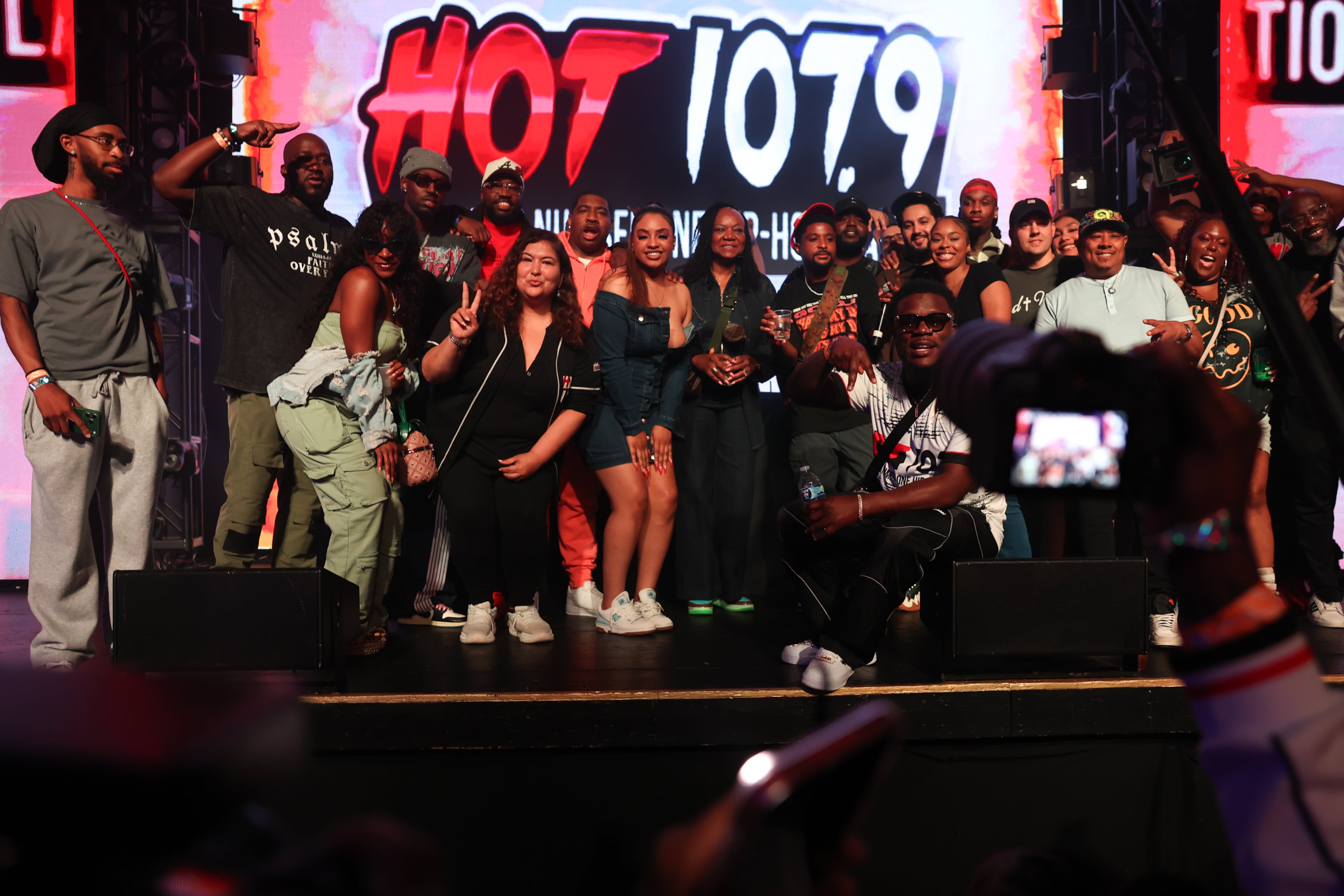 Hot 107.9 staff gather for a photo on stage at the Who’s Hot Showcase at Believe Music Hall. (Arvin Temkar/AJC)
