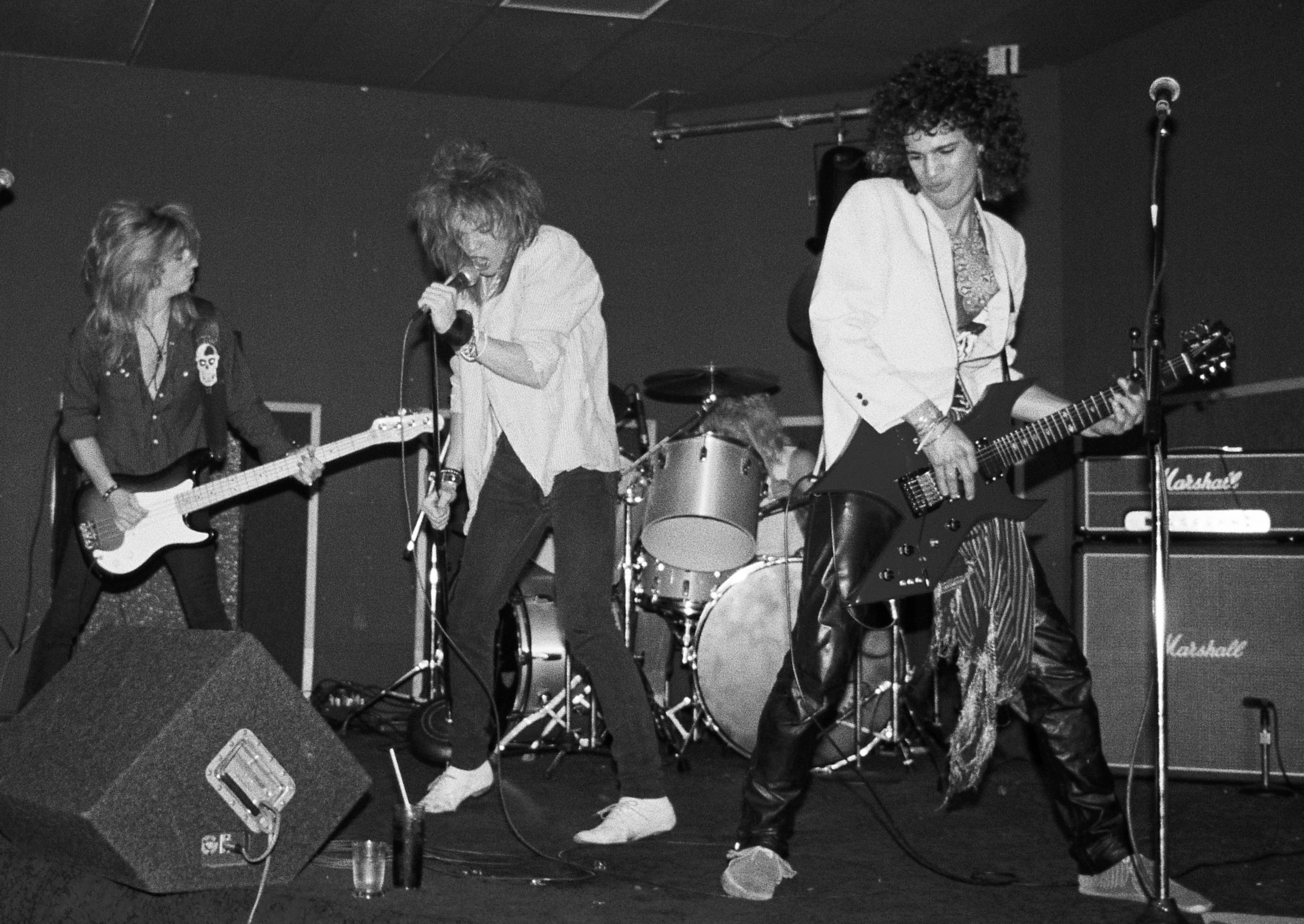 (L-R) Steve Darrow, Axl Rose, Steven Adler (behind the drums) and Slash of the rock group 'Hollywood Rose' perform at the Madame Wong's East on June 28, 1984 in Los Angeles, California. (Photo by Marc S Canter/Michael Ochs Archives/Getty Images)