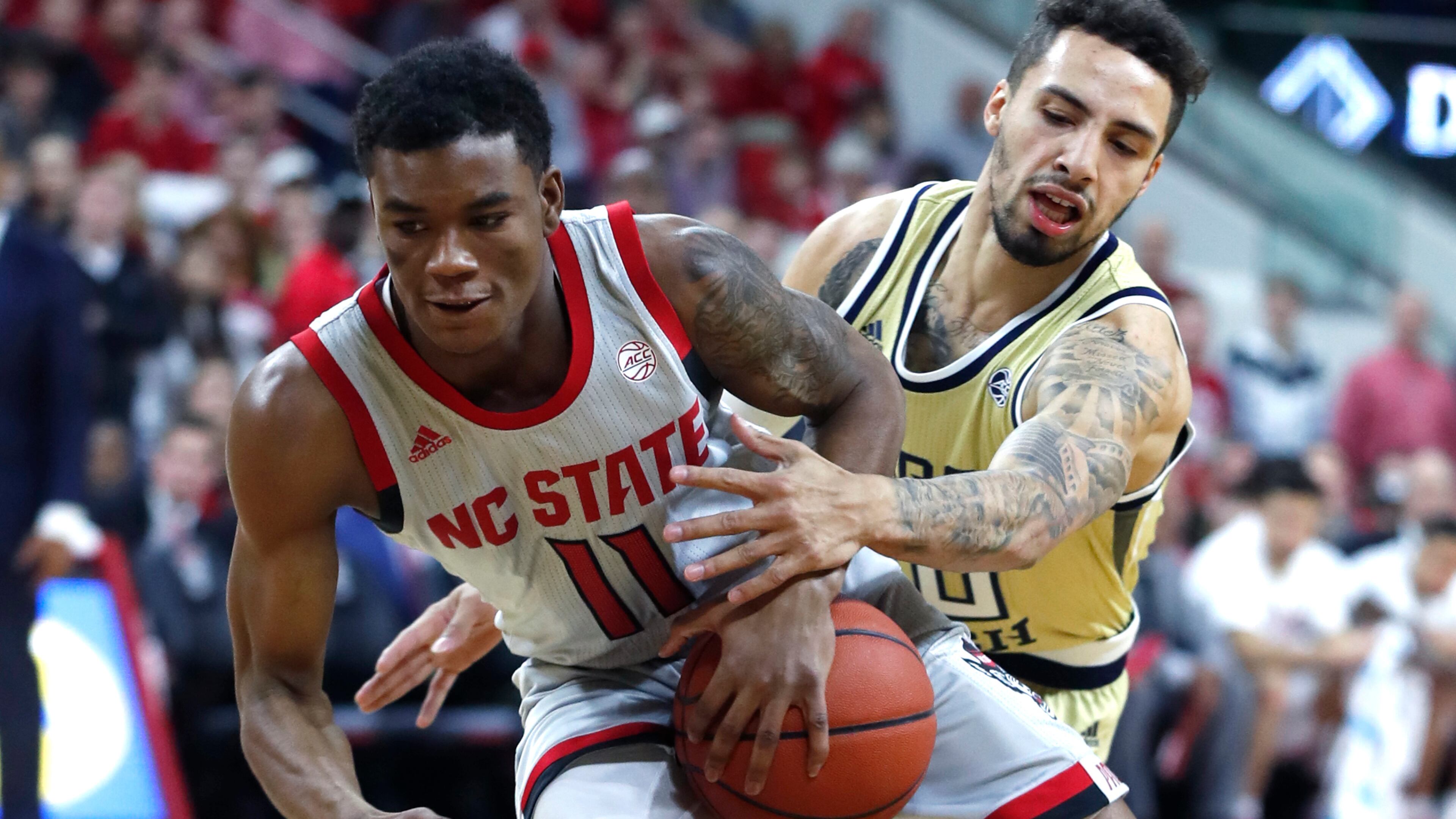 North Carolina State's Markell Johnson (11) drives around Georgia Tech's Jose Alvarado (10) during the first half Wednesday, March 6, 2019, in Raleigh, N.C.