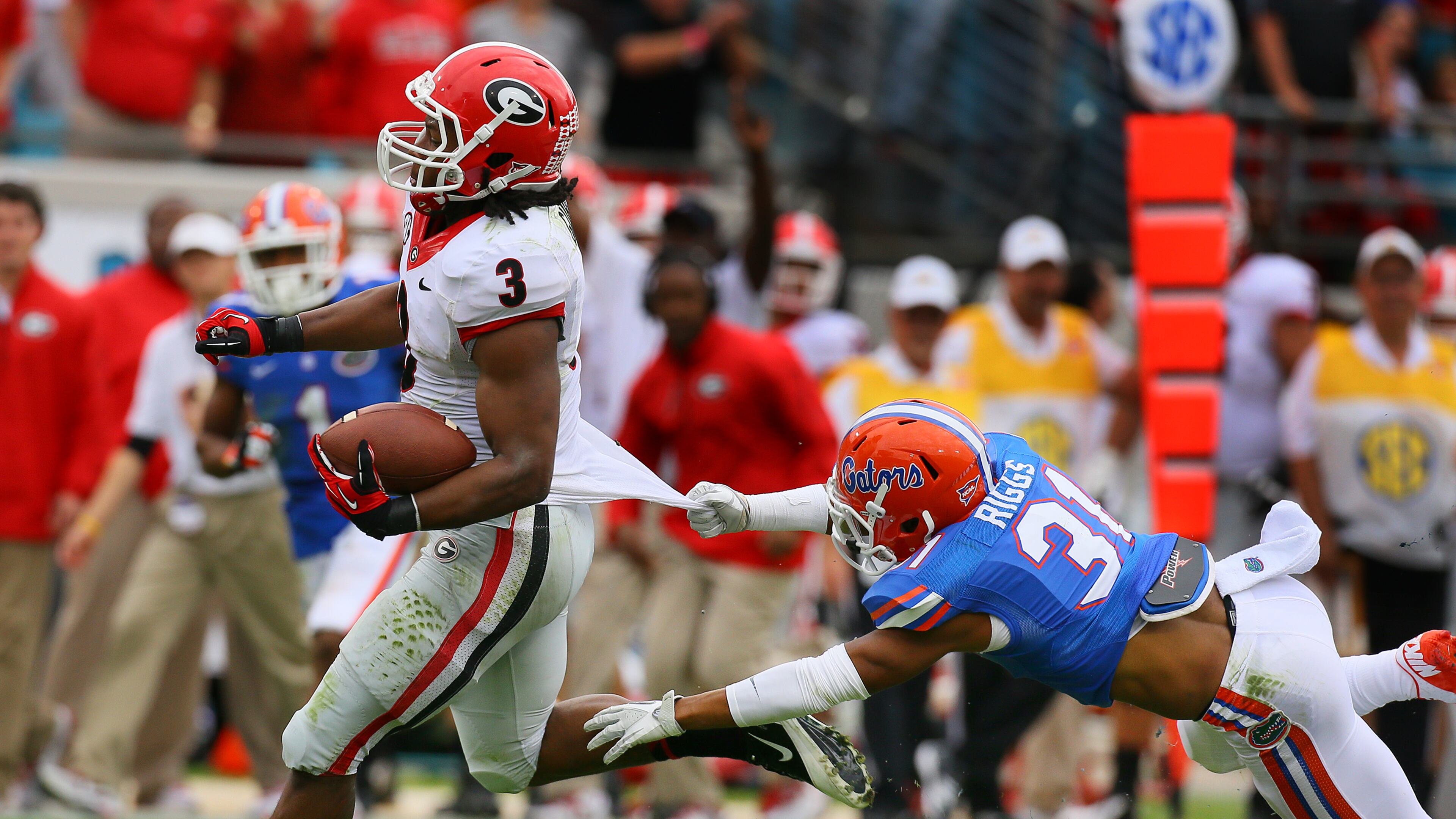 Georgia tailback Todd Gurley breaks away from Florida defensive back Cody Riggs who can't hold on to his jersey for a 70-yard plus touchdown run and a 14-0 lead during the first quarter on Saturday, Nov. 2, 2013, in Jacksonville.