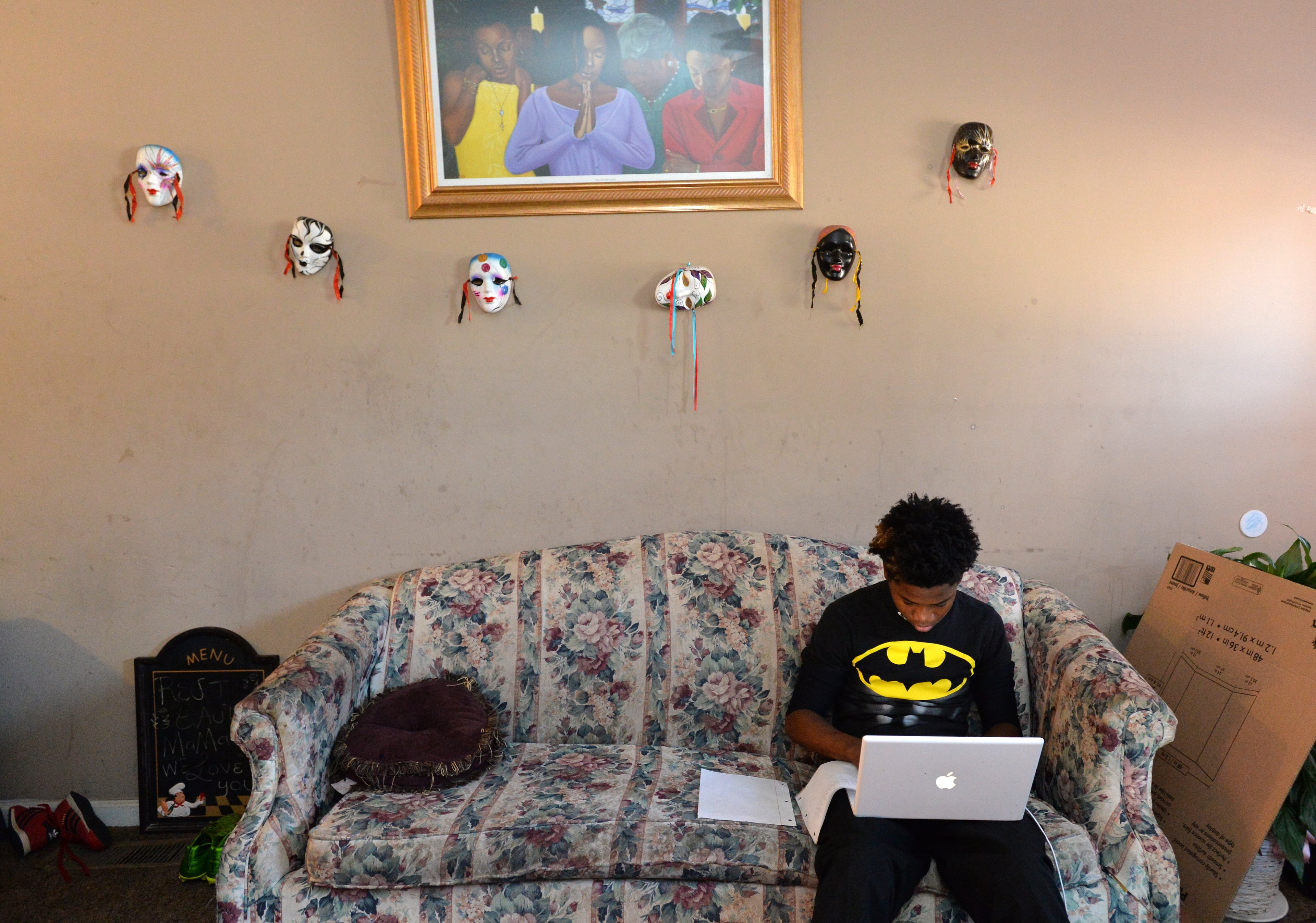 Dayzhon, aka “Chopper,” works on a school project on a donated computer in the family’s west Atlanta home. When Donna’s cancer spread to her spine and her legs quit working, it was Dayzhon who carried her to the bathroom. HYOSUB SHIN / HSHIN@AJC.COM