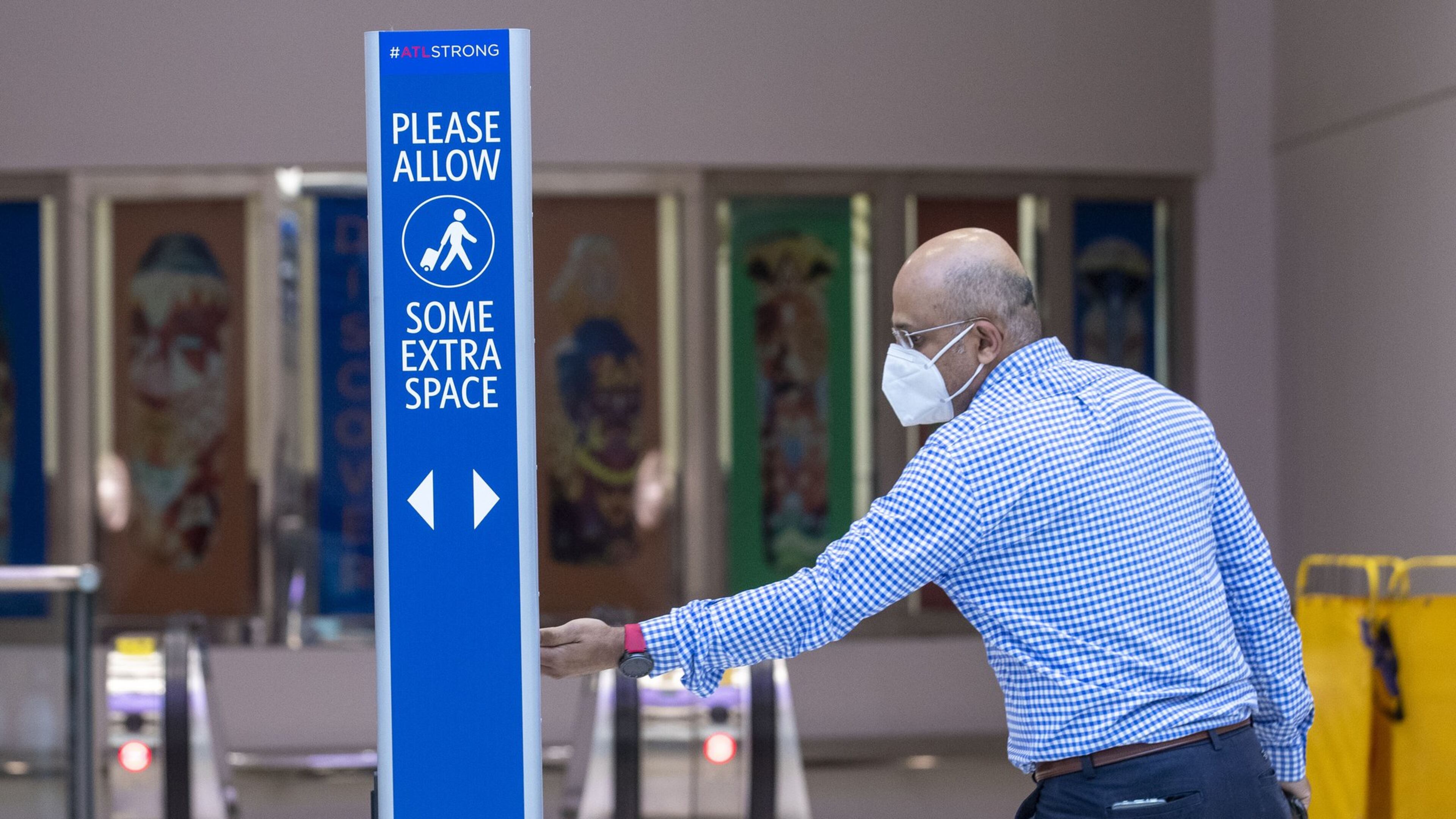 A man uses a hand sanitizing station located in the domestic terminal at Hartsfield-Jackson International Airport in Atlanta, Wednesday, May 20, 2020. (ALYSSA POINTER / ALYSSA.POINTER@AJC.COM)