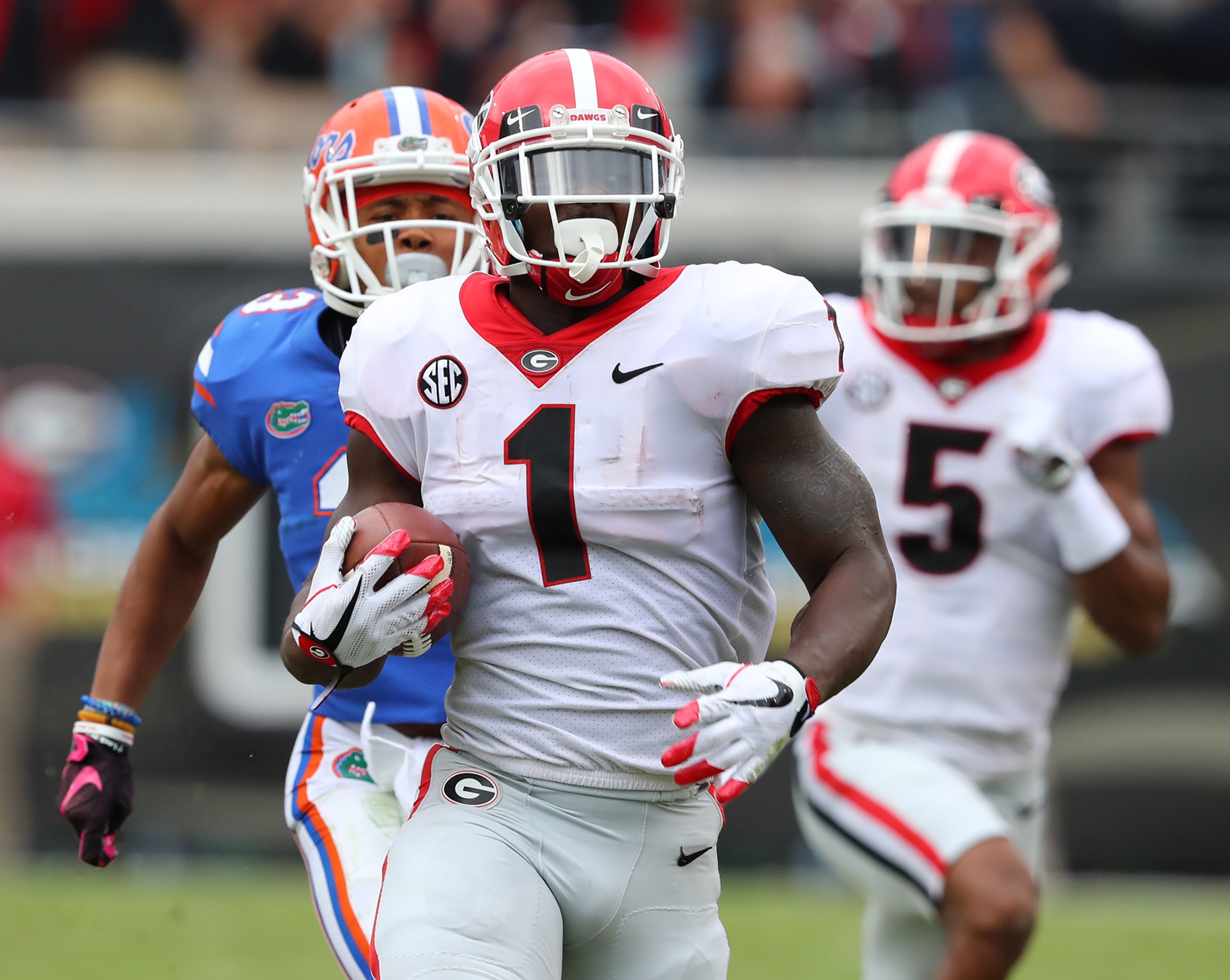 October 28, 2017 Jacksonville: Georgia tailback Sony Michel breaks away from Florida defenders for a long touchdown run to take a 21-0 lead during the first quarter in the Georgia-Florida NCAA college football game on Friday, October 27, 2017, in Jacksonville. Curtis Compton/ccompton@ajc.com