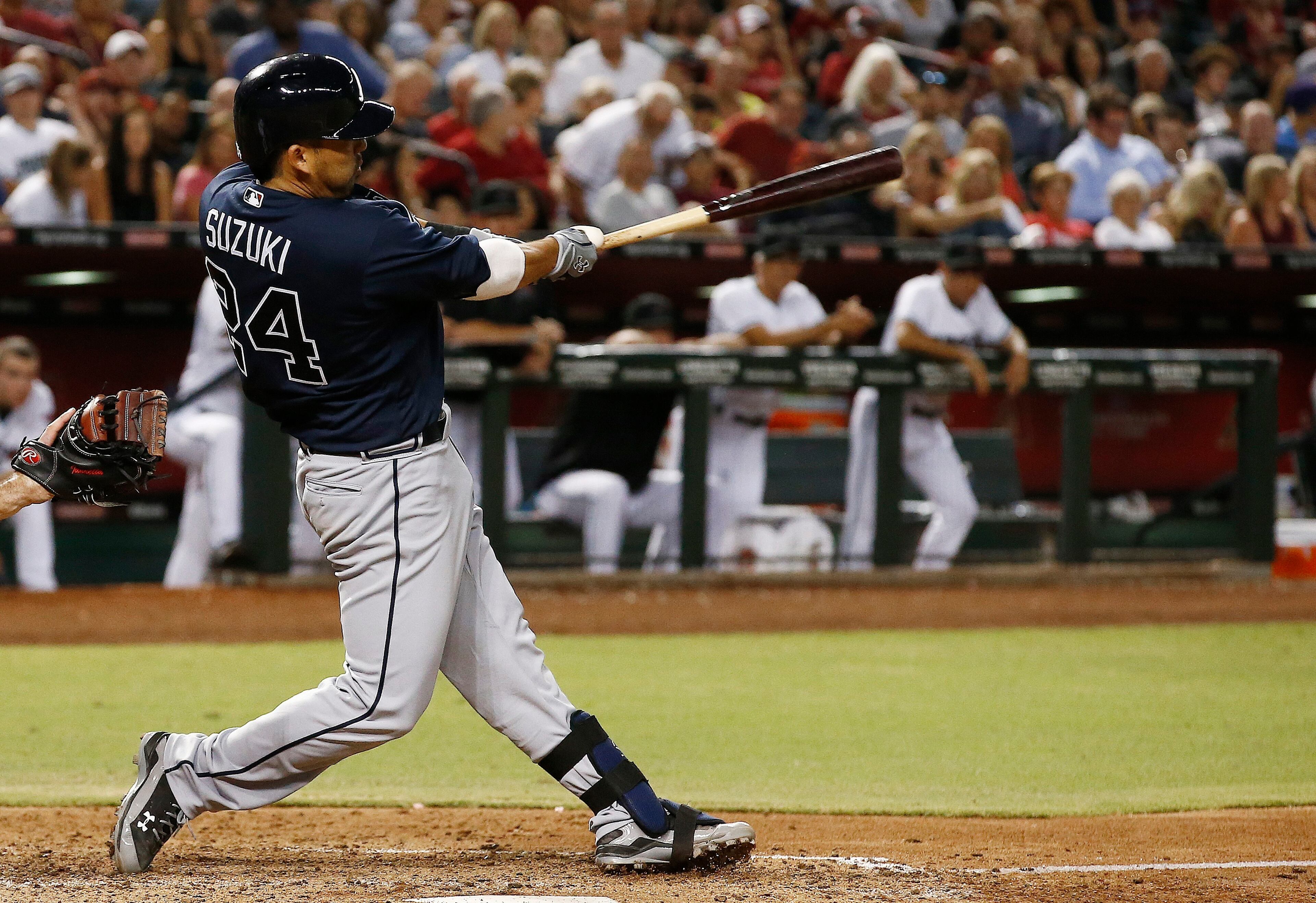 Atlanta Braves' Kurt Suzuki swings on a two-run home run against the Arizona Diamondbacks during the seventh inning of a baseball game Tuesday, July 25, 2017, in Phoenix. (AP Photo/Ross D. Franklin)