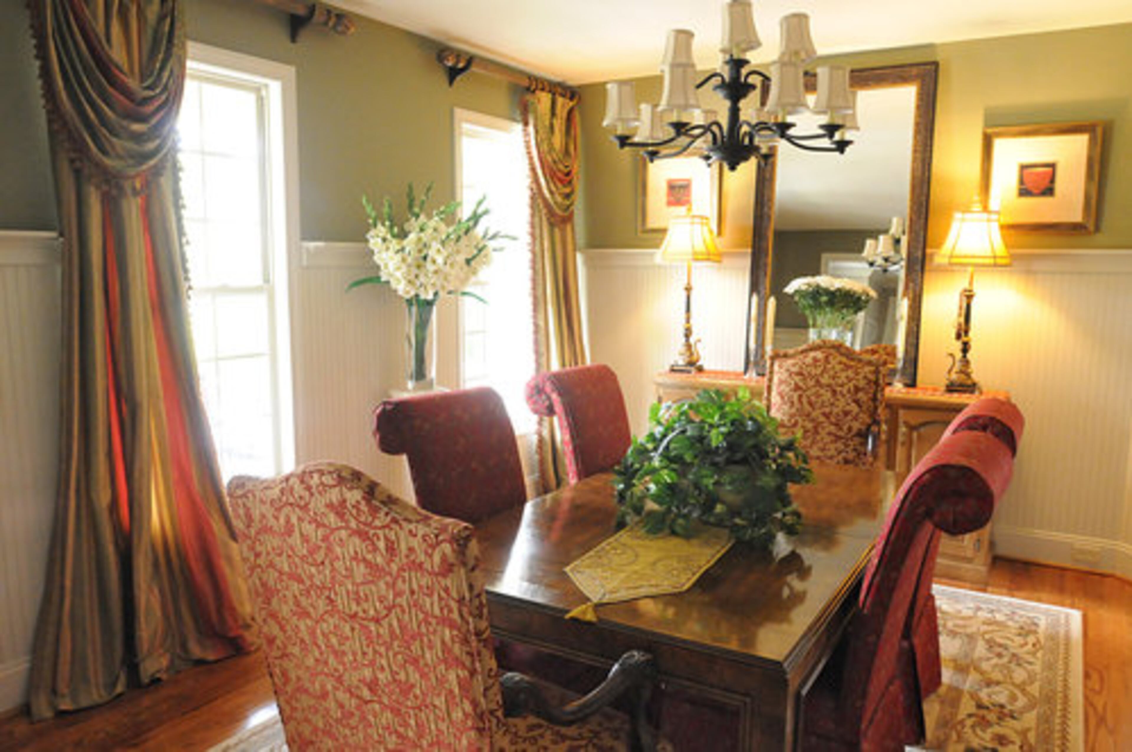 "The dining room is one of our favorites because of the bold colors we choose to use in this room. The red side chairs were purchased in Hilton Head... The pecan dining table is 35 years old and was purchased in Columbus, Ga., Sylvia's home town, and has traveled with us all over the United States," James Mays says.