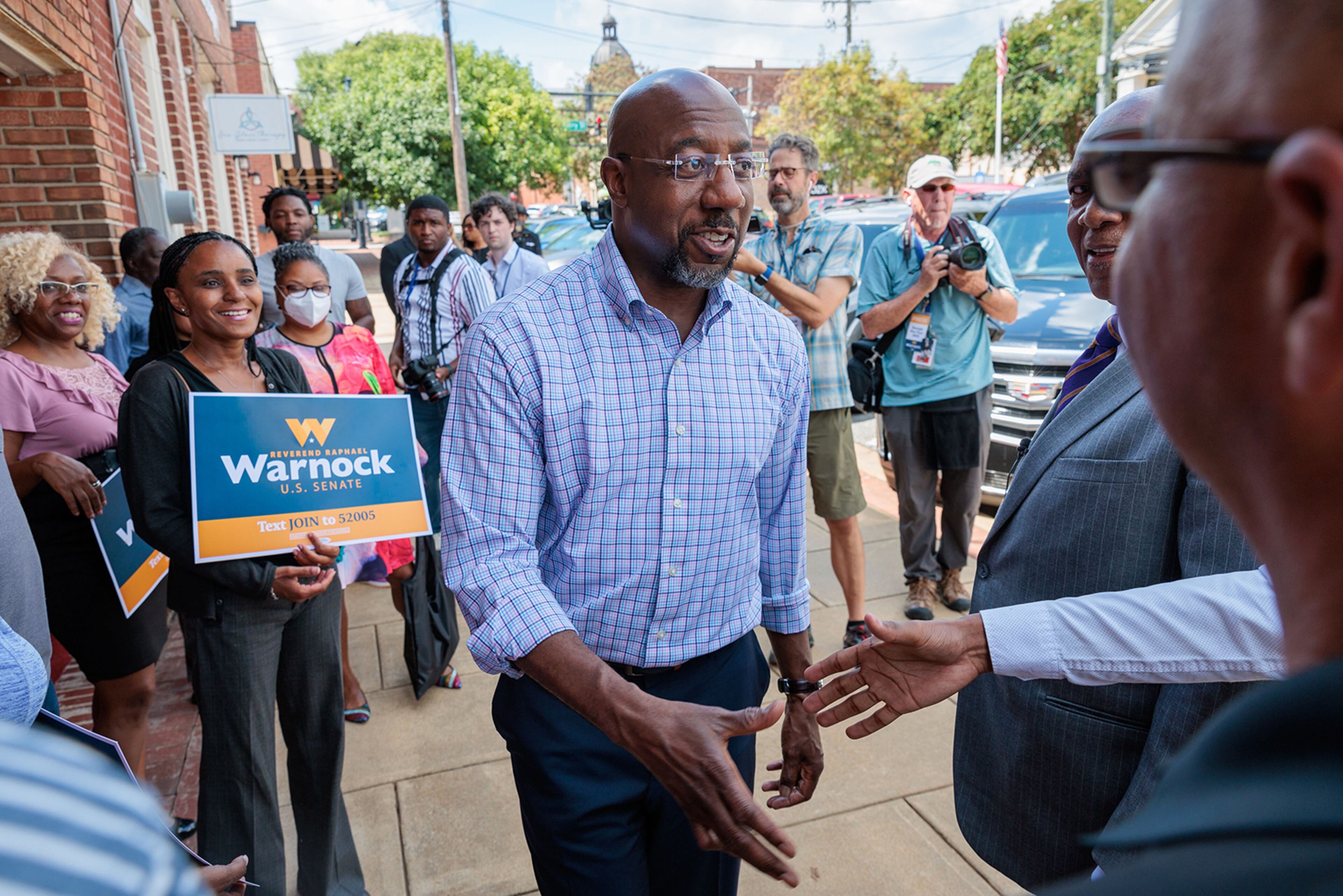Political perspective has a lot to do with how someone views today's economy. At a rally for Democratic U.S. Sen. Raphael Warnock, supporters were willing to give national policies more time to solve the problems of inflation. (Arvin Temkar/Atlanta Journal-Constitution/TNS)