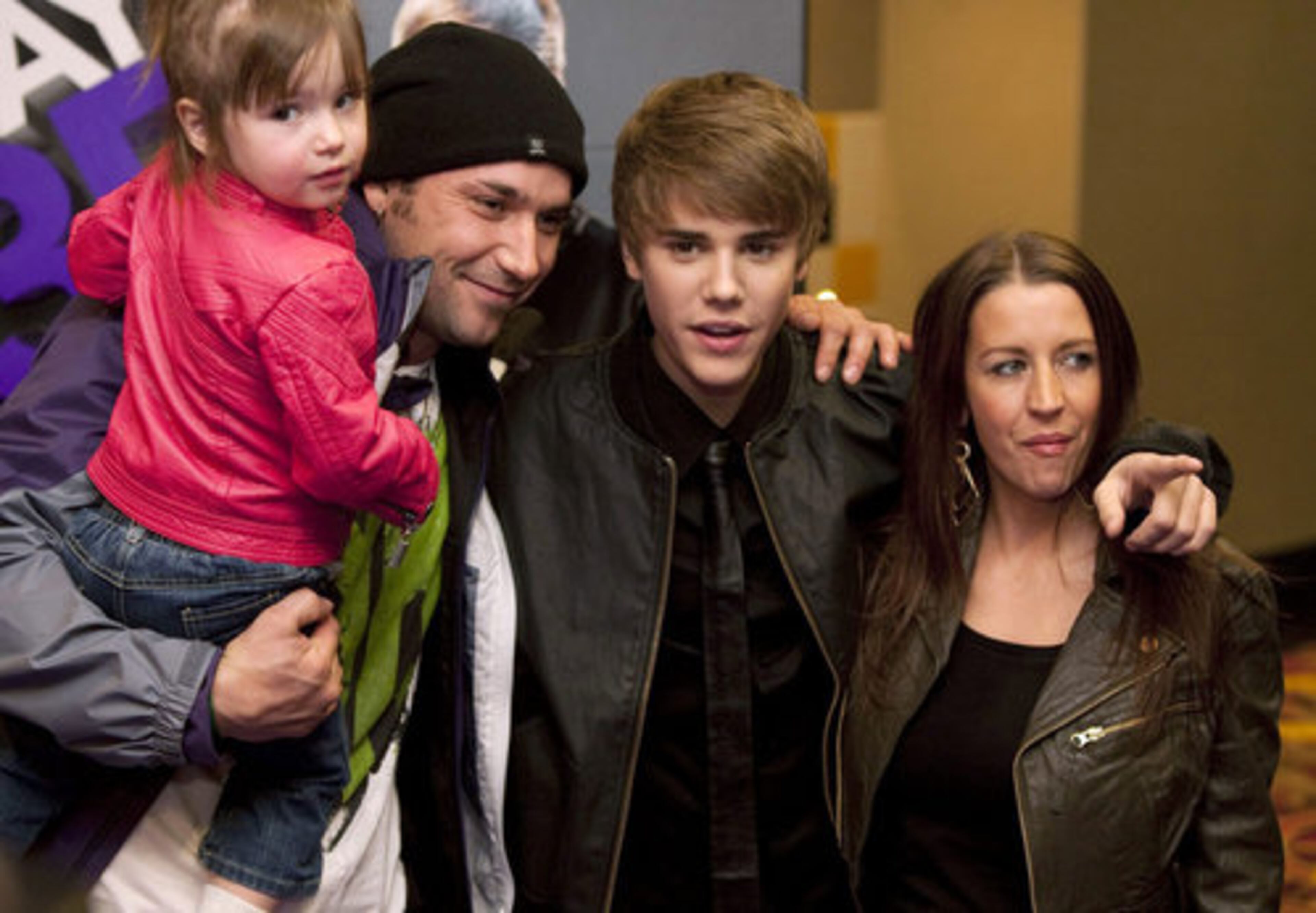 Singer Justin Bieber, center, poses with his mother Pattie Lynn Mallette, right, father Jeremy Bieber and sister Jazmyn prior to the screening of his new film "Justin Bieber: Never Say Never" in Toronto Tuesday, Feb. 1, 2011.