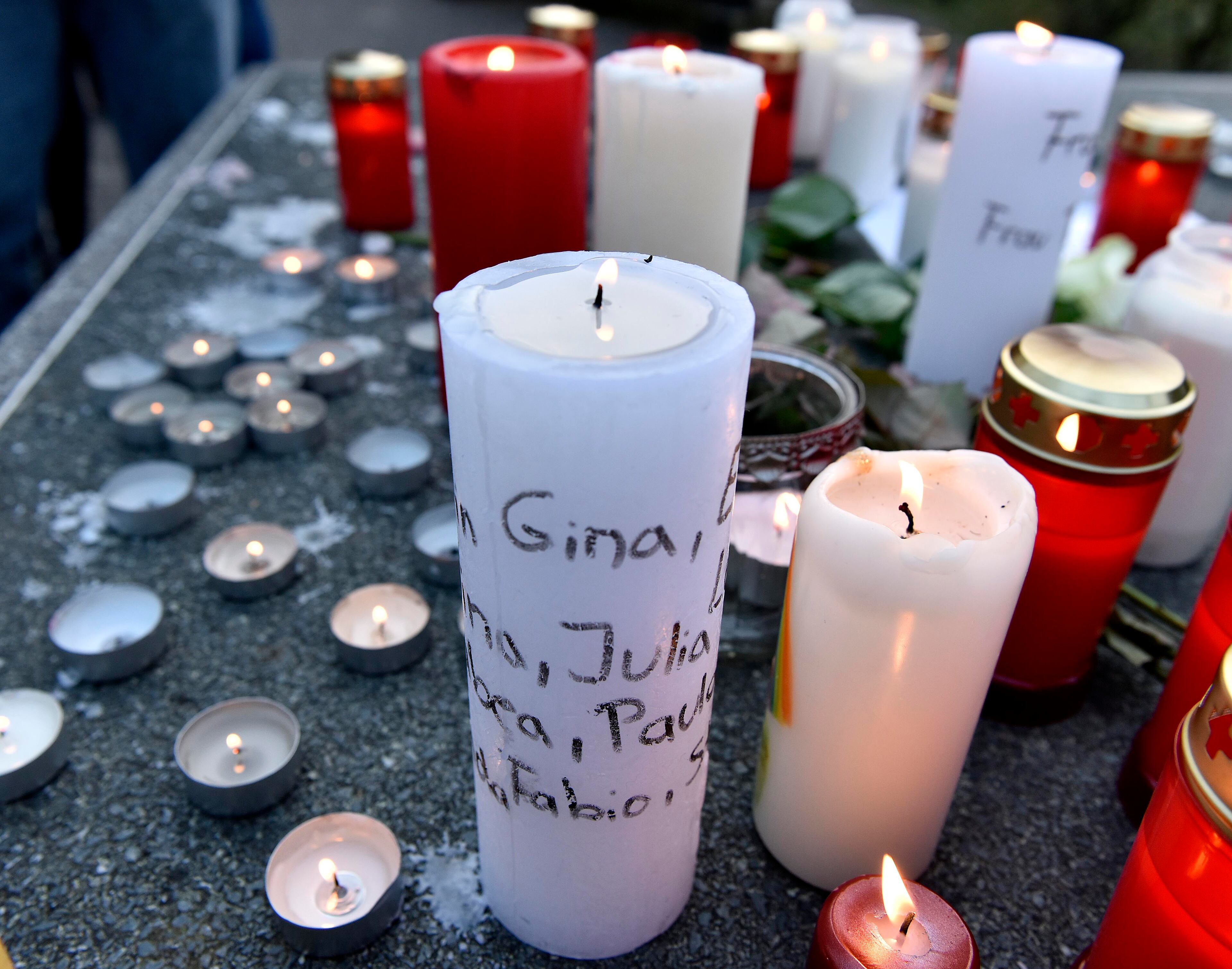 Candles with names written on it are placed a table tennis table in front of the Joseph-Koenig Gymnasium in Haltern, western Germany Tuesday, March 24, 2015. A Germanwings plane from Barcelona crashed on its way to Duesseldorf over the French alps, 16 students and 2 teachers from Haltern were among the 150 people on board. (AP Photo/Martin Meissner)