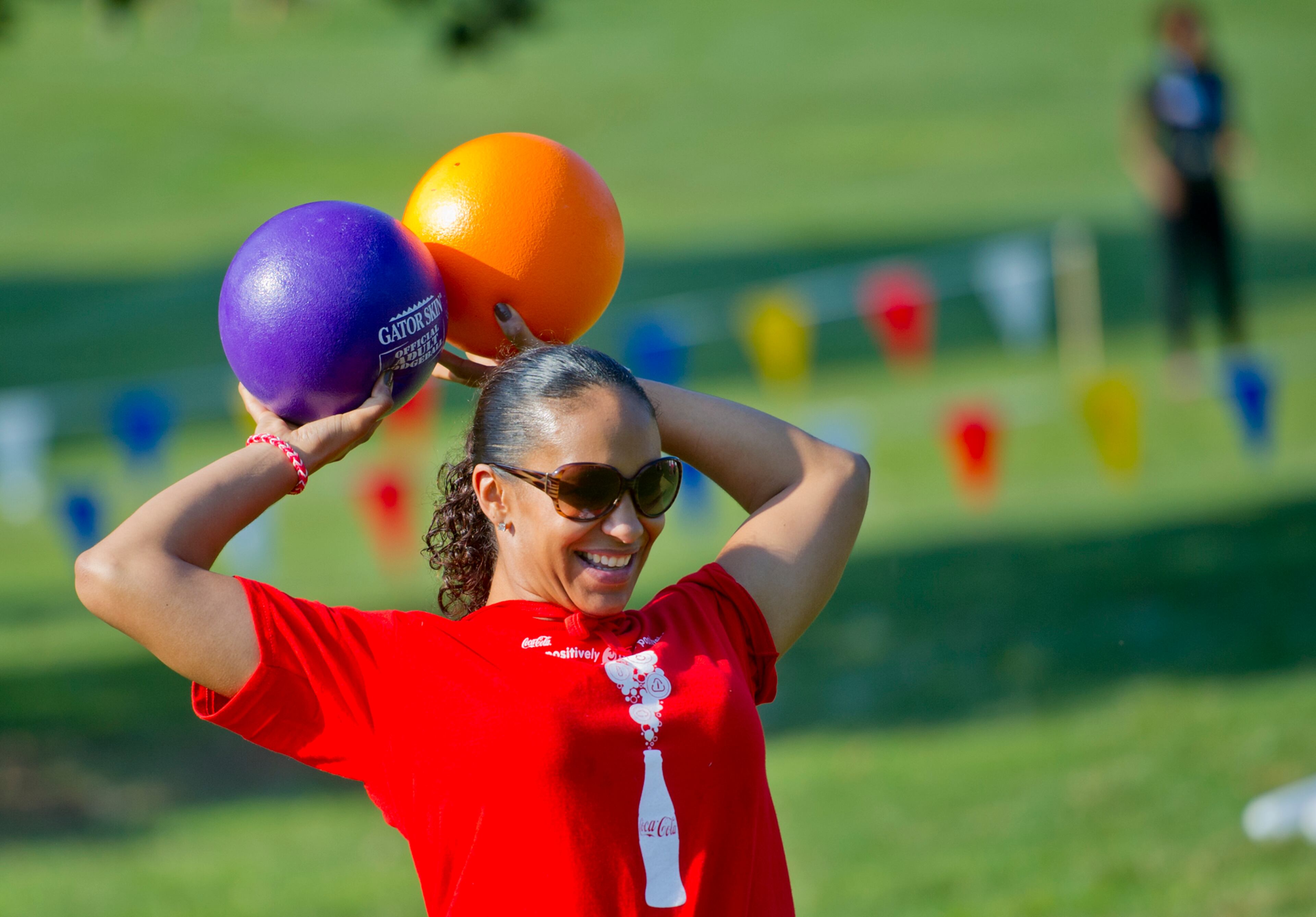 Summer Butler looks for a target as sheholds two balls over her head during a game of dodgeball during the Boys & Girls Clubs of America's Day for Kids at Piedmont Park in Atlanta on Saturday, September 7, 2013. Day for Kids is a national initiative to raise awareness for critical issues facing young men and women. With more than a decade of tradition, Day for Kids invites adults to act like kids again by participating in field day events such as relay races, dodge ball, tug of war and lots of other activities. JONATHAN PHILLIPS / SPECIAL
