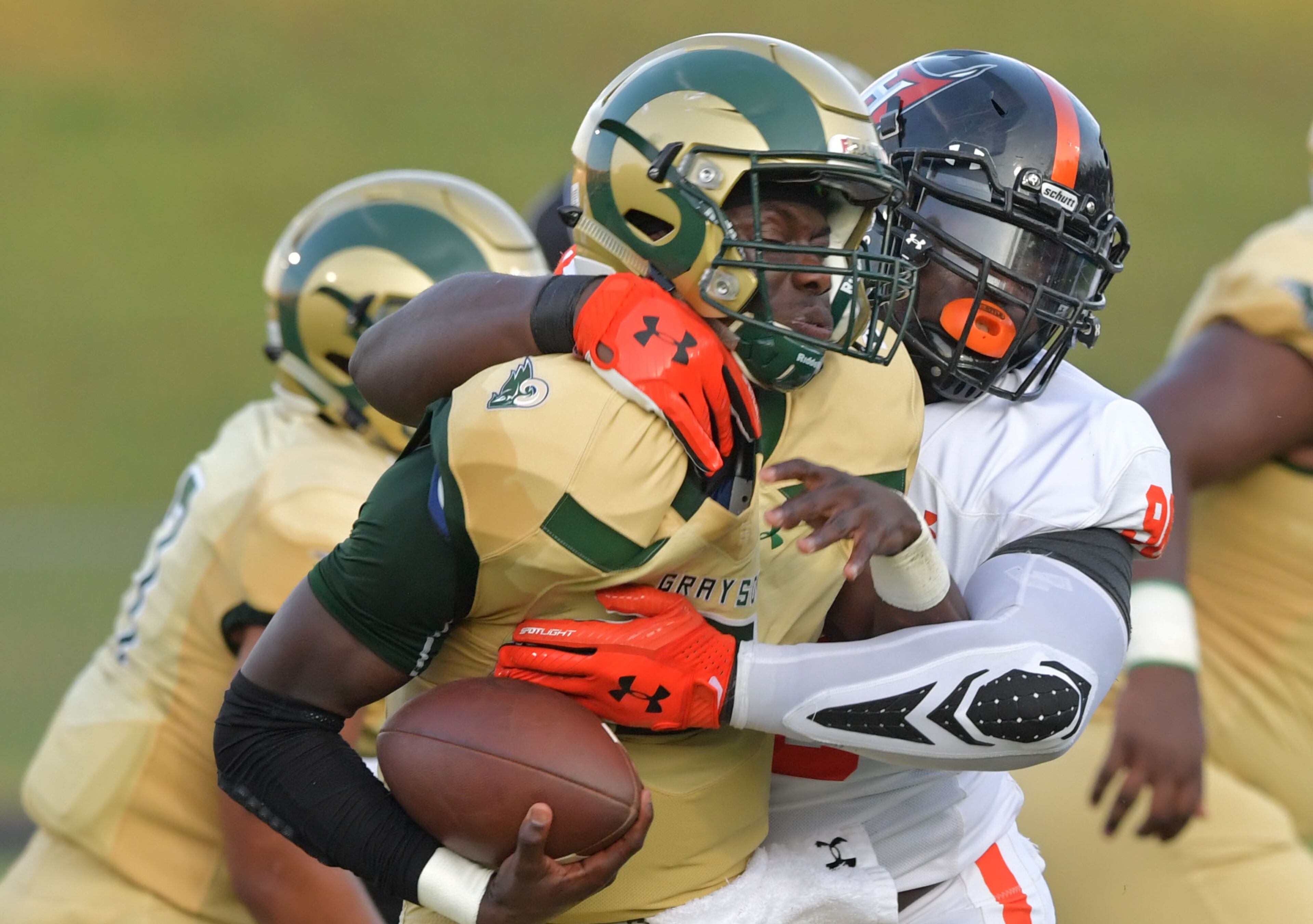 Grayson's Demarcus Irons (3) is taken down by Hoover's Kaleb Gibbs (98) in the first half of Friday's game.