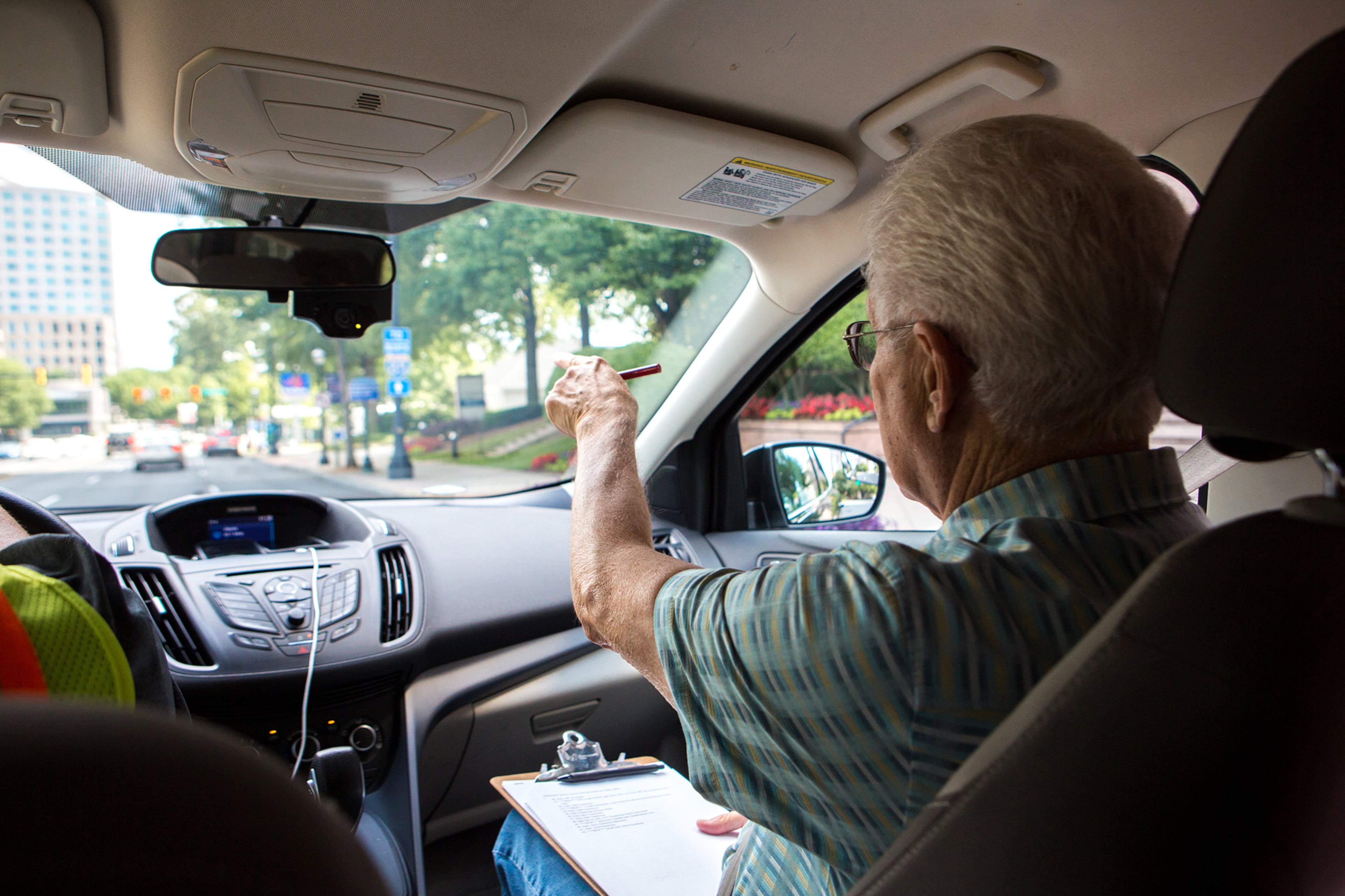 Jack Abbott, 74, course director of the AJC Peachtree Road Race, surveys the progress of potholes and problem areas during a ride along with Atlanta Public Works employees along Peachtree Road in Atlanta, Ga., on Wednesday, June 19, 2019. Abbott, who is serving in his 21st and final year as volunteer course director, says that he starts the prep work for the race each year in late May, after which he works on it every day until the event itself on July 4. "I'm a perfectionist," says Abbott. "I can't reach that but I try." (Casey Sykes for The Atlanta Journal-Constitution)