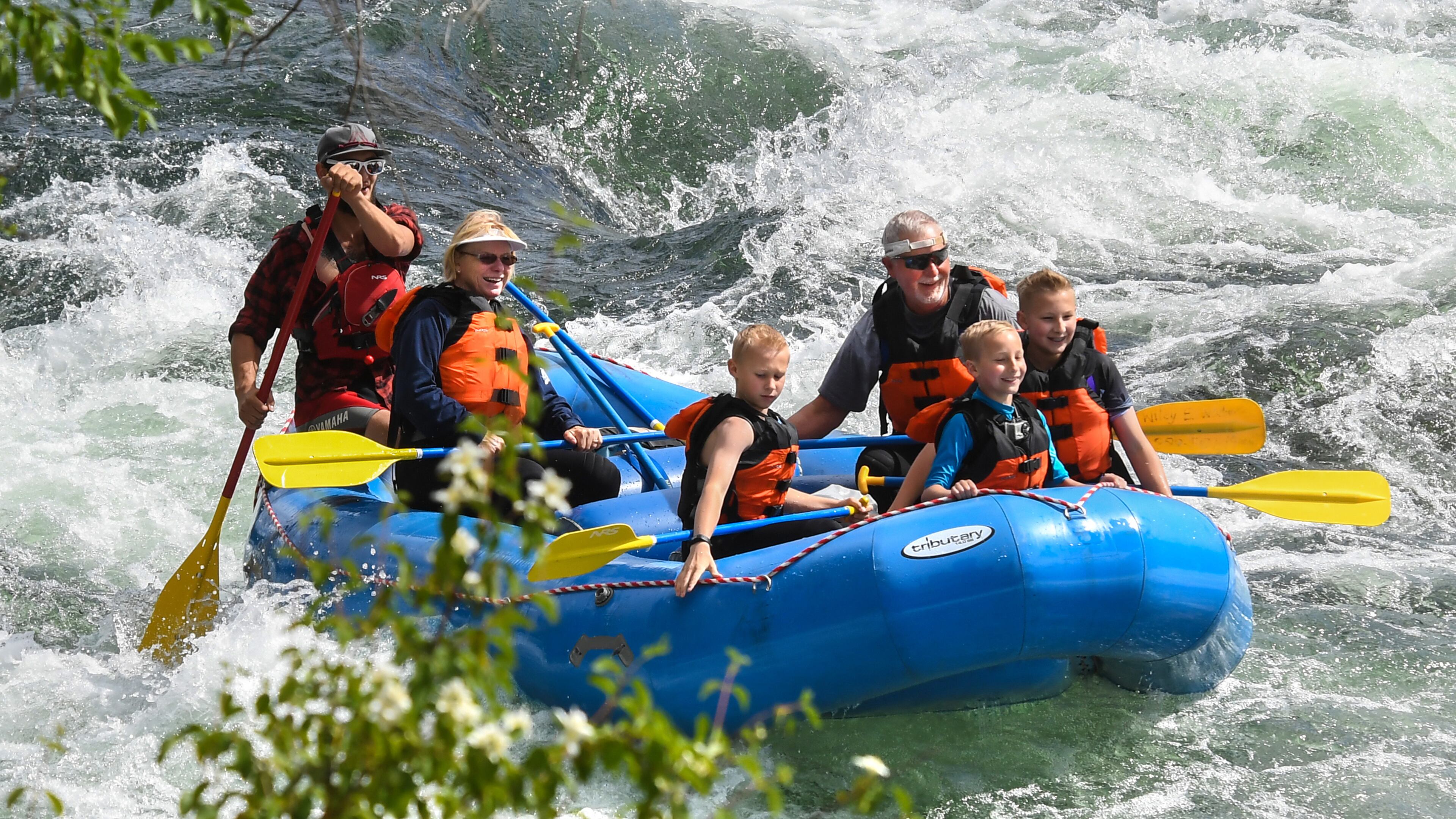 The Decker family, from left, Linda, Brandon, Andy, Colin and Alec, take a trip down the Spokane River with Wiley E. Waters Whitewater Rafting, Thursday, June 14, 2018. Linda and Andy gave their grandchildren the trip as a Christmas gift. (Dan Pelle/Spokesman-Review/TNS)